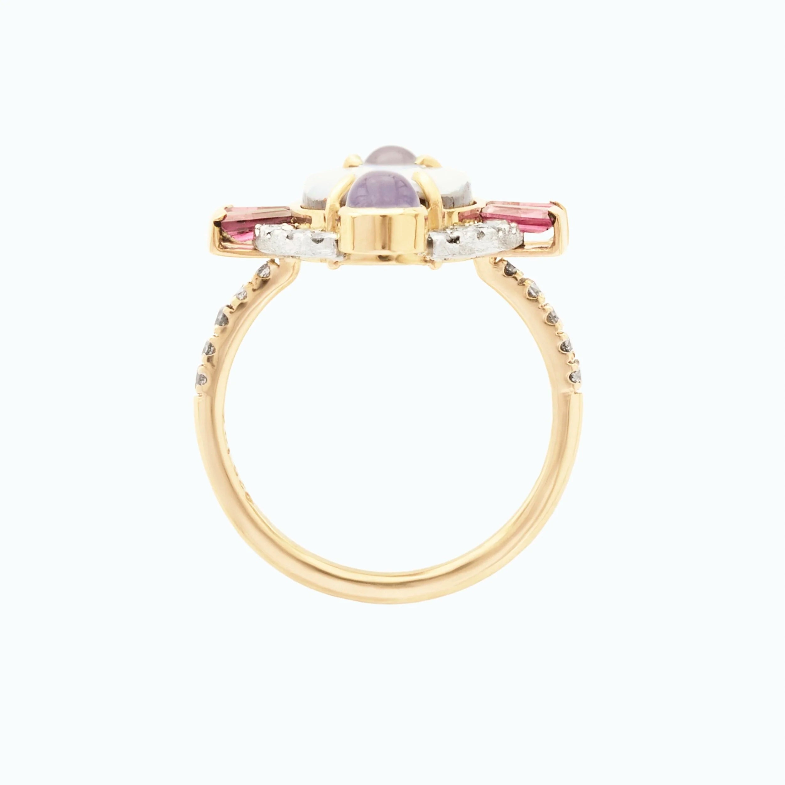 Gold ring with multicolored gemstones on a white background