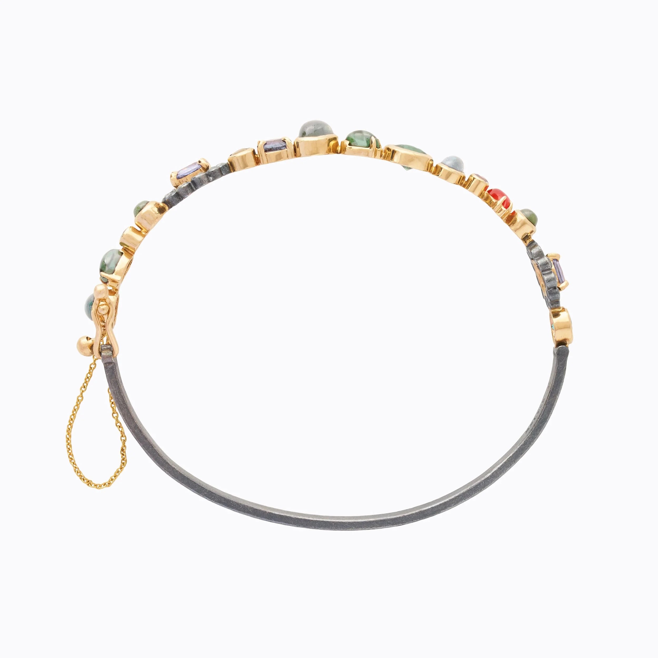 cuff with gemstones and safety chain and box clasp on a white background