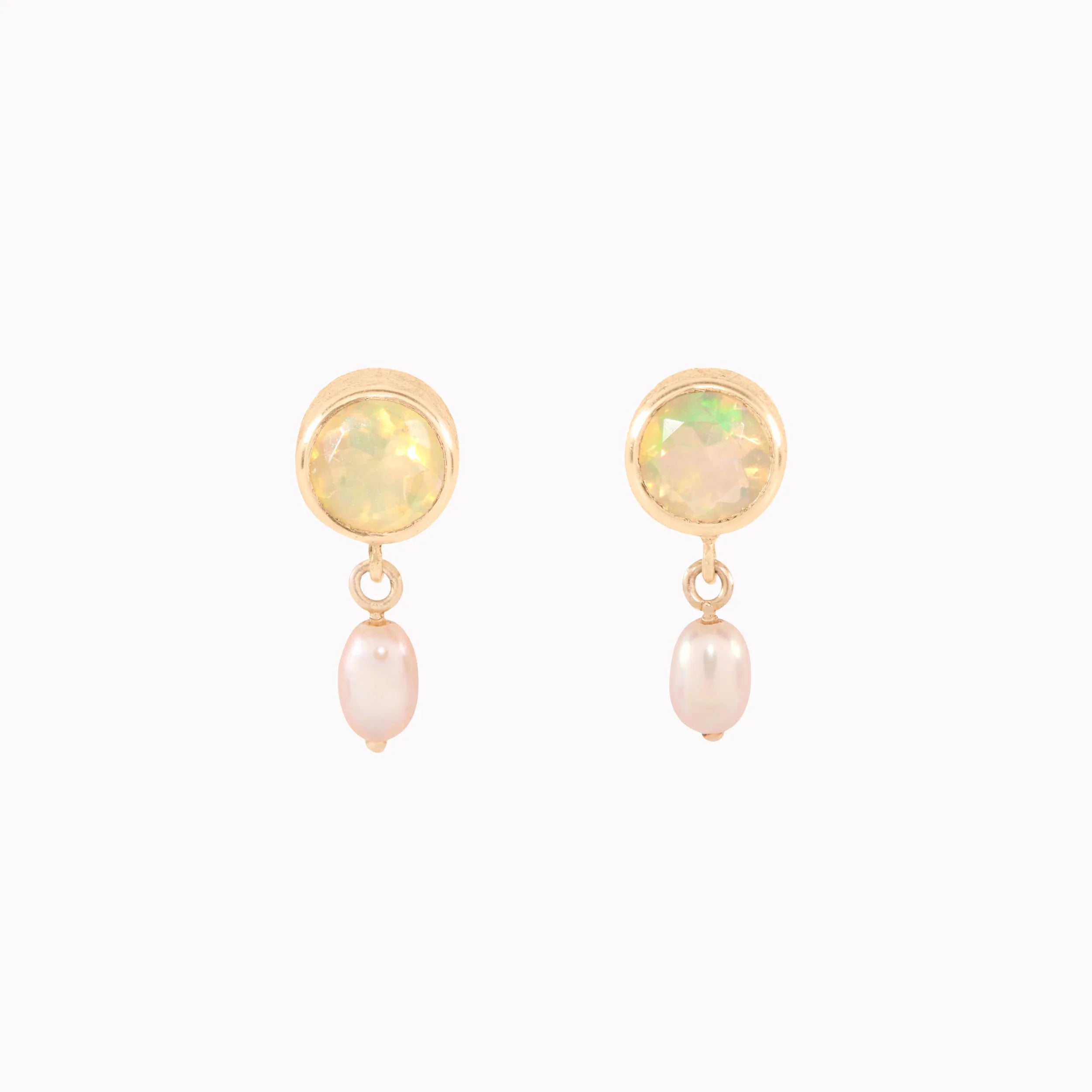 Pair of earrings with opal and pearl stones on a white background