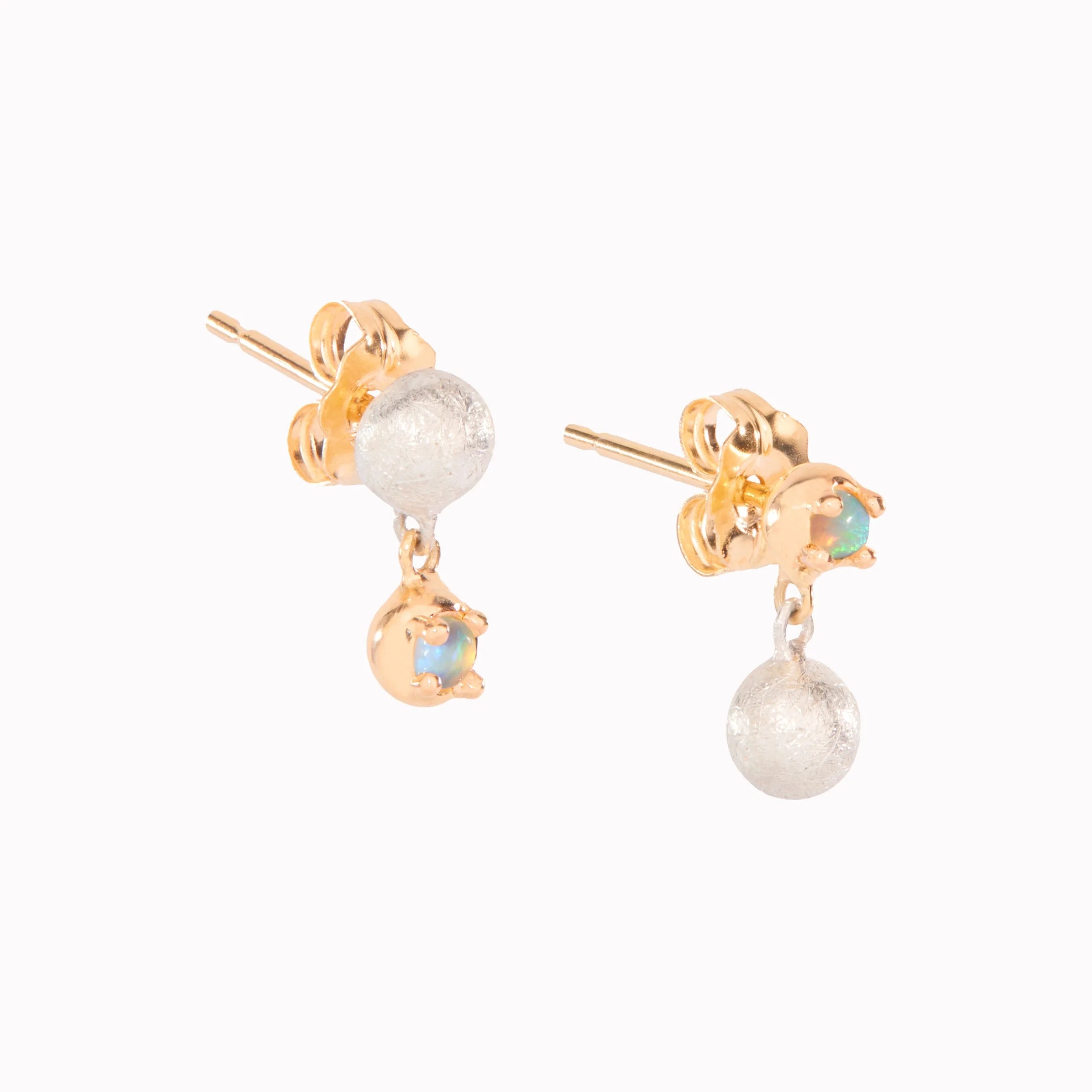 Pair of gold earrings with gold and opal drops on a white background