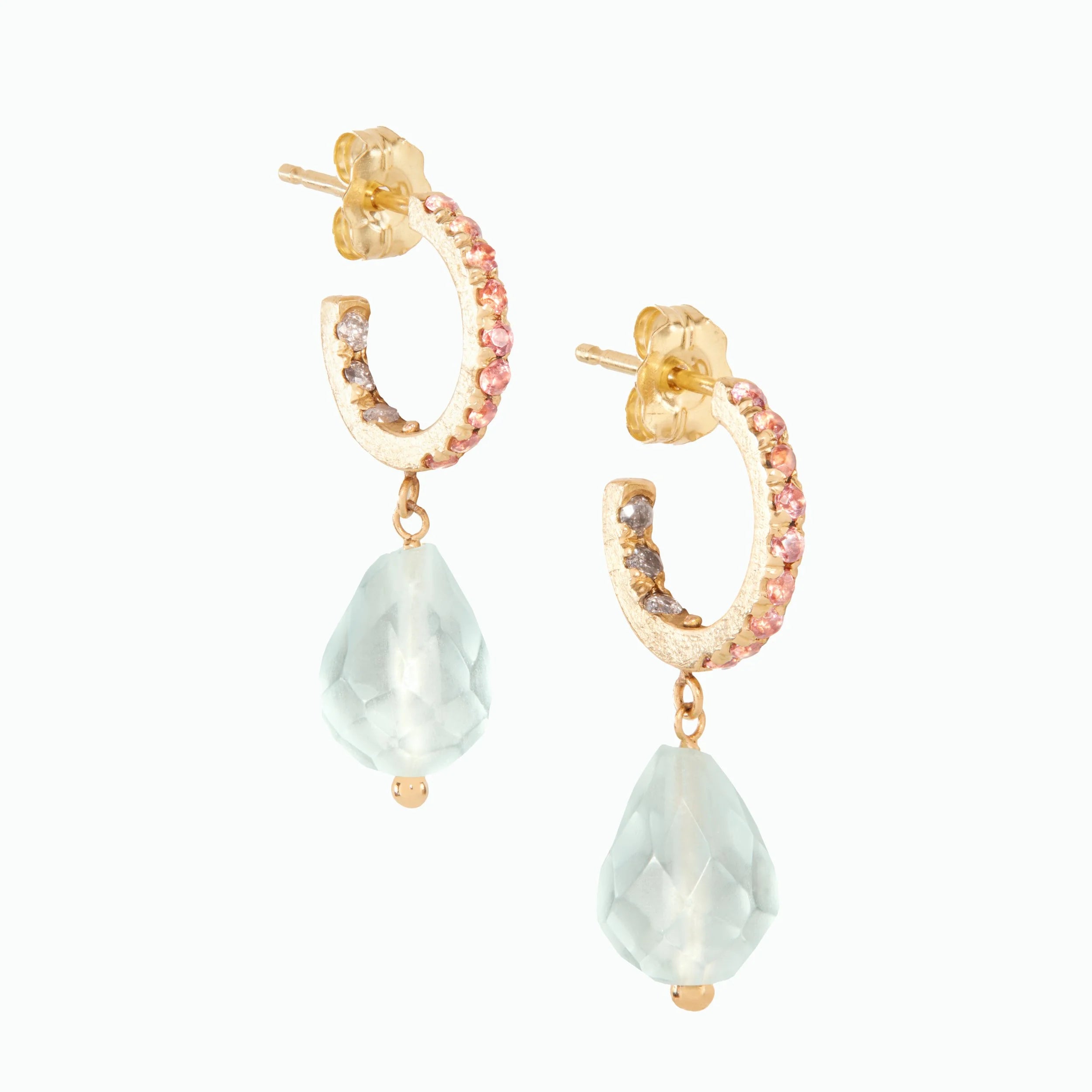 Gold hoop earrings with small pink stones and blue drops on white background.