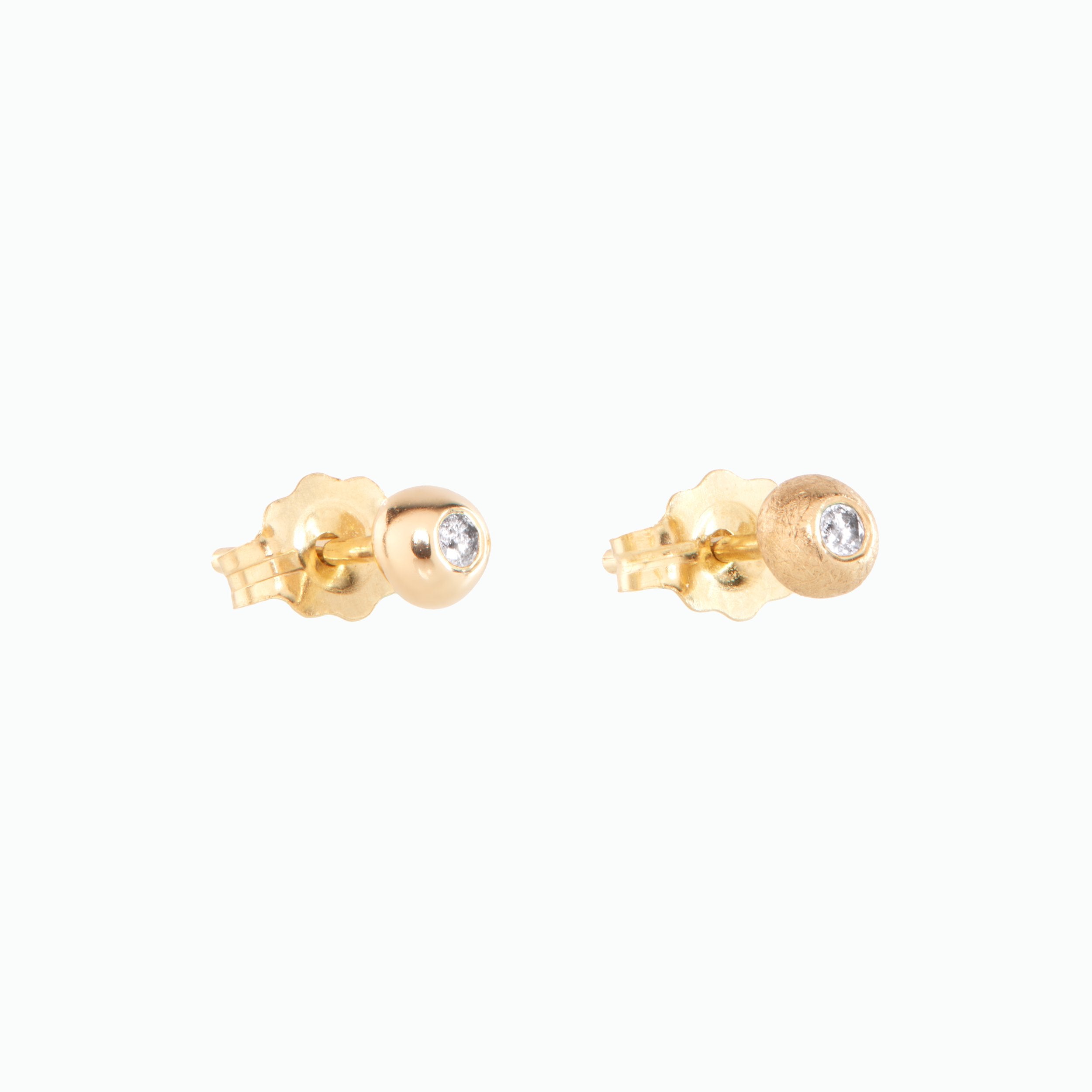 Gold earrings with small diamonds on a white background
