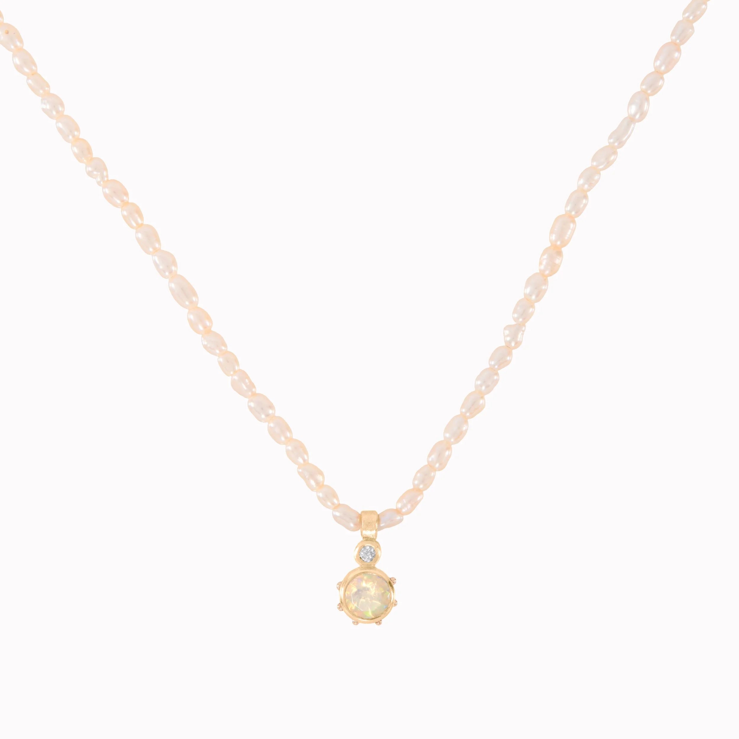 Delicate necklace with a small pendant on a white background