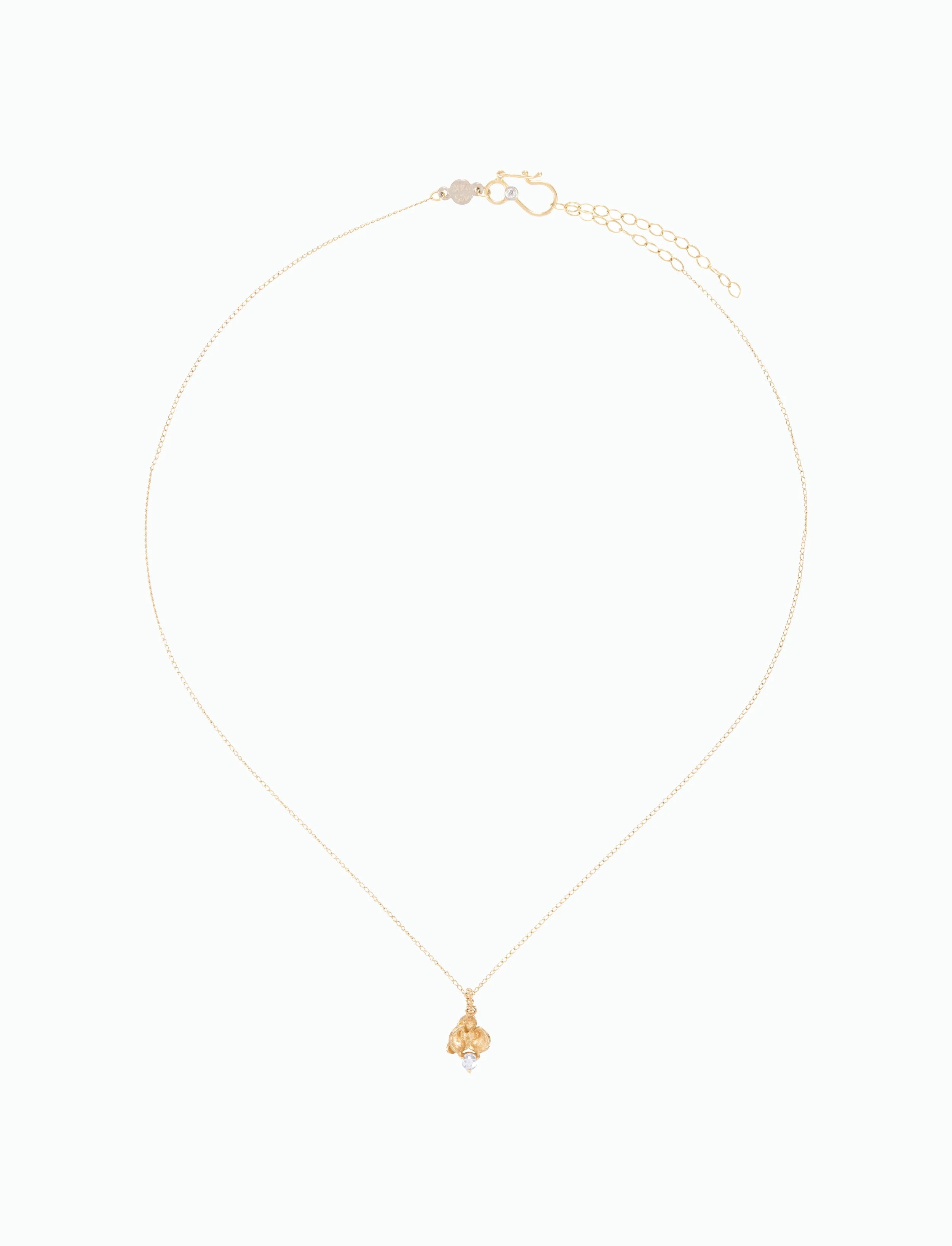 Gold necklace with a small pendant on a white background