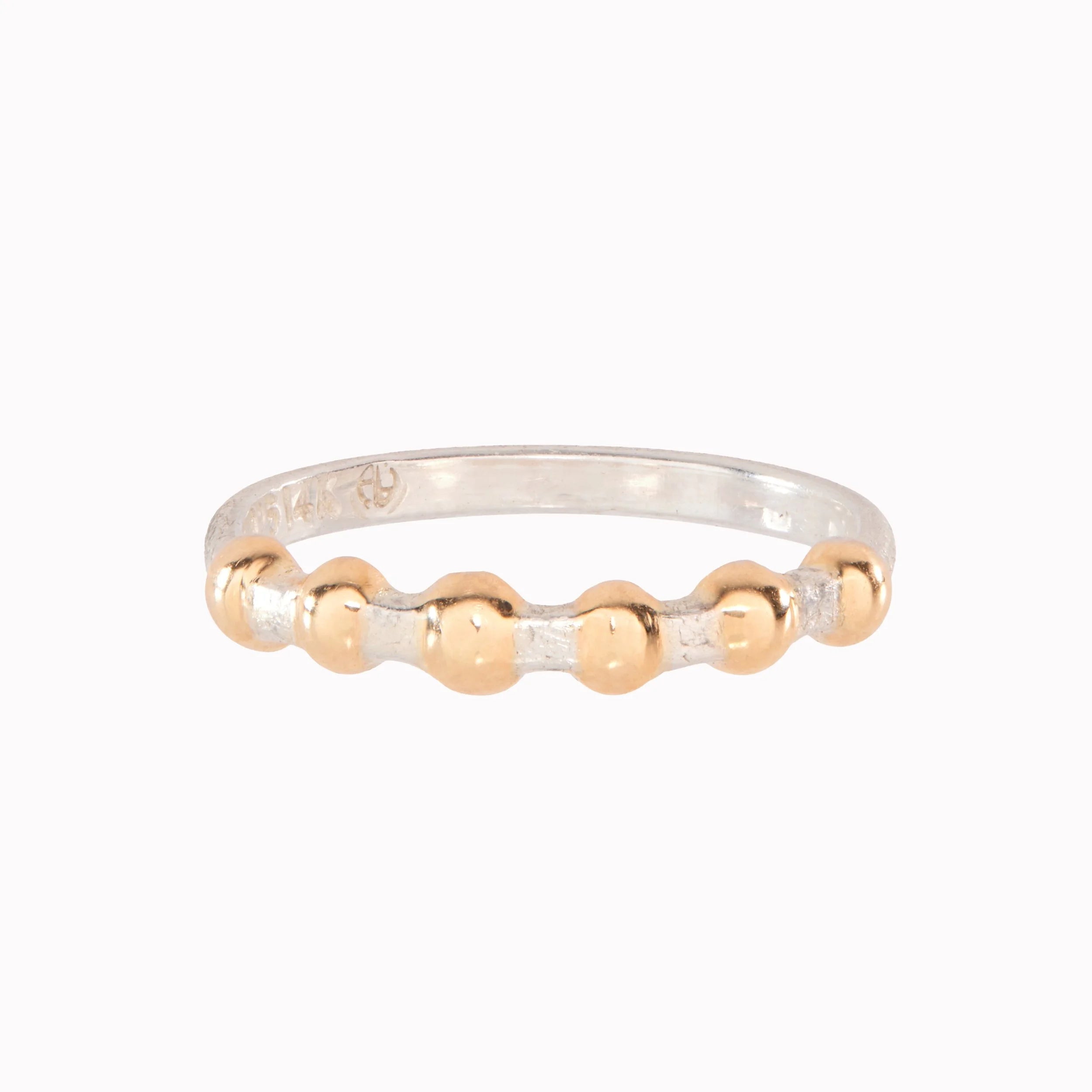 Two-tone ring with gold and silver beads on a white background