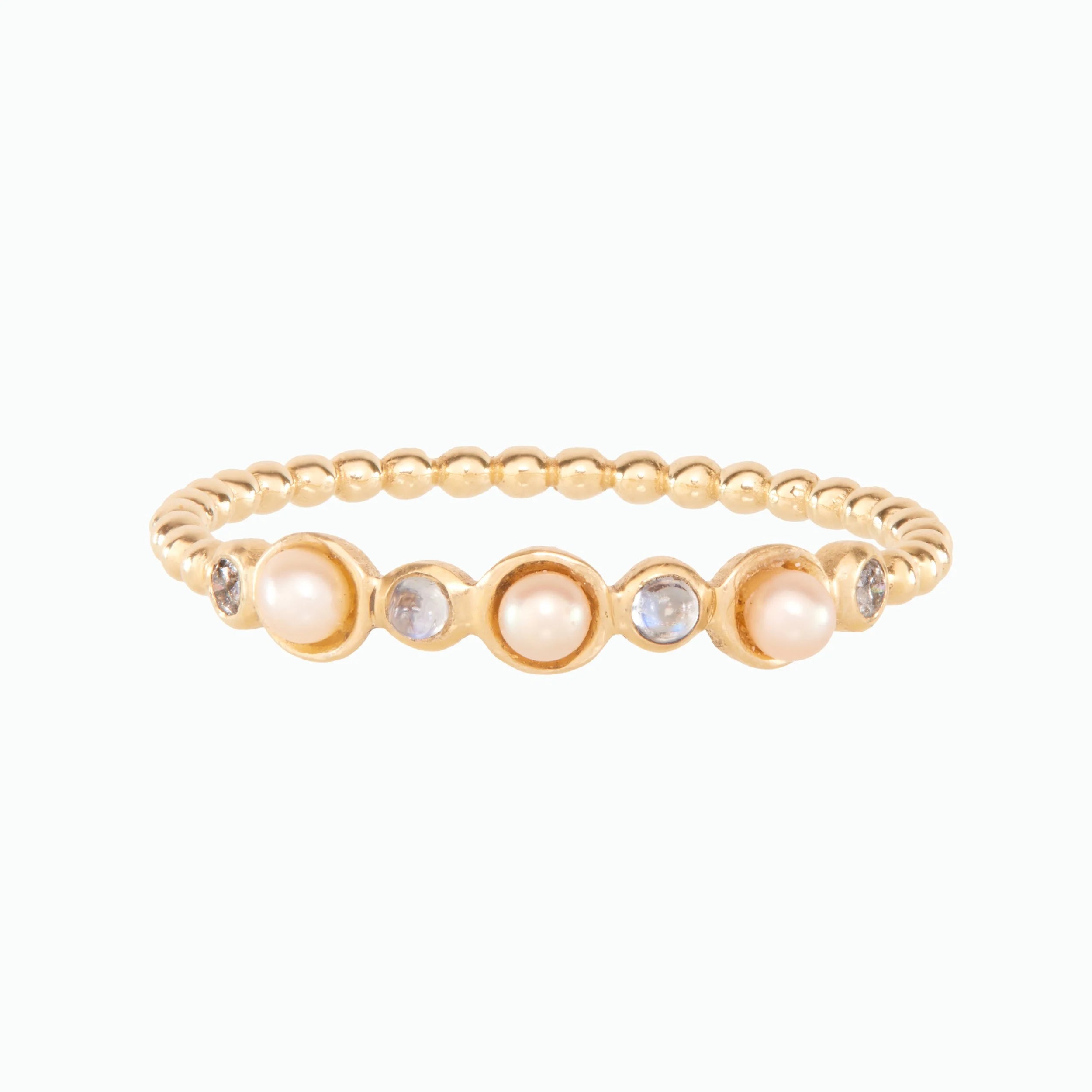 Gold ring with pearls and small stones on a white background