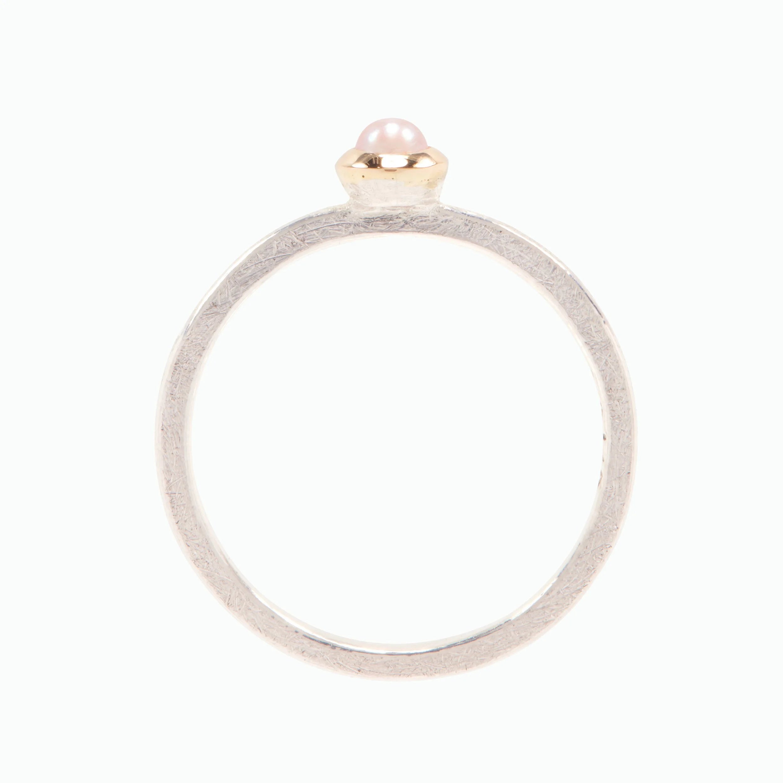 Silver ring with a small pearl on a white background