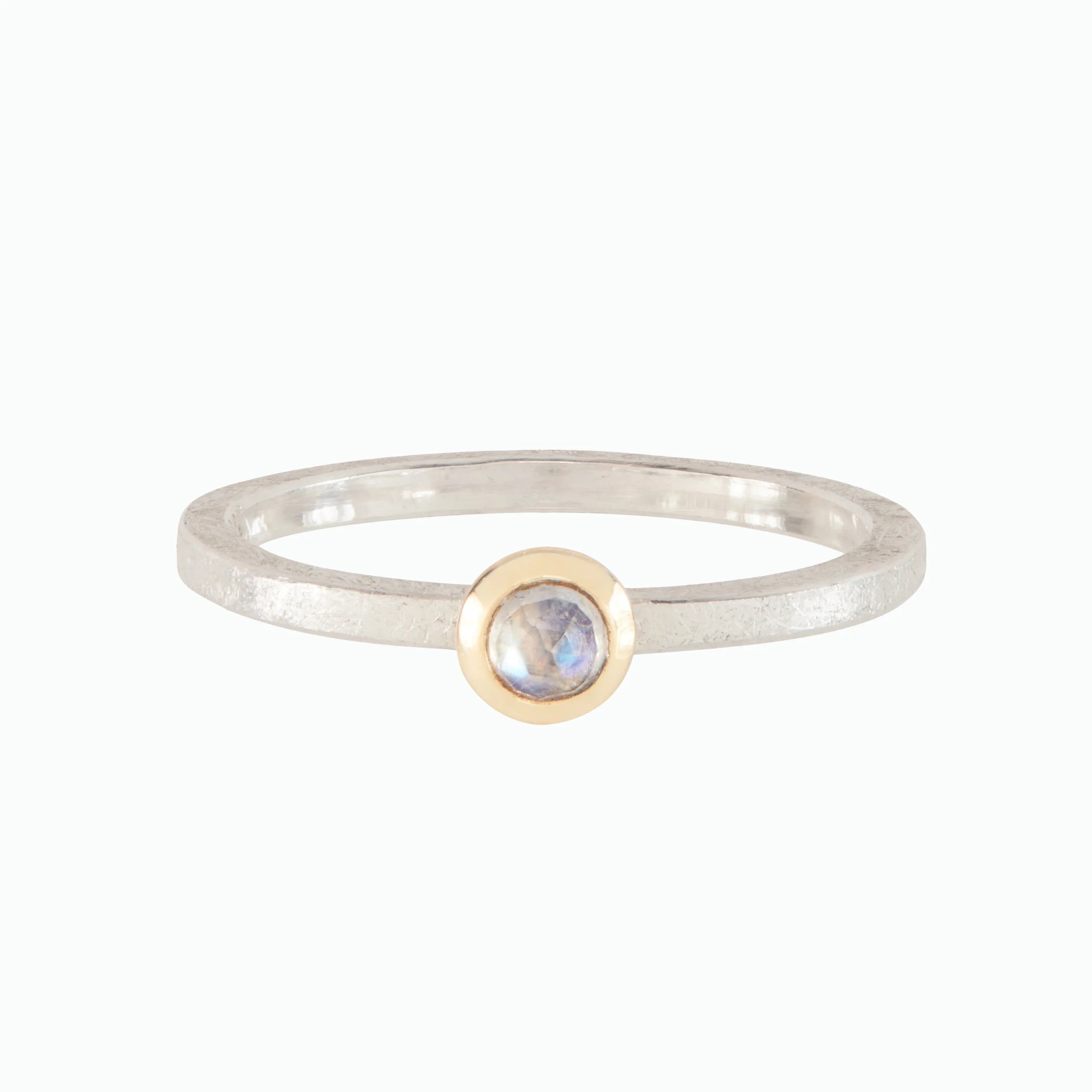 Silver ring with a gold accent and gemstone on a white background