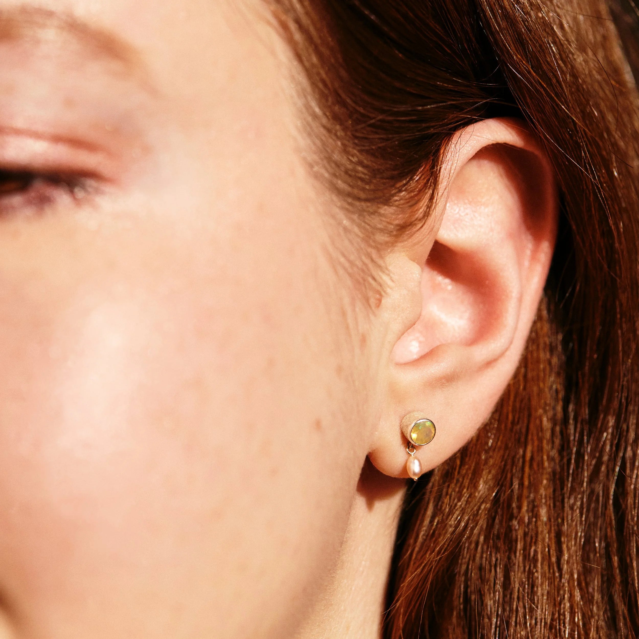 Close-up of an ear with a gold earring