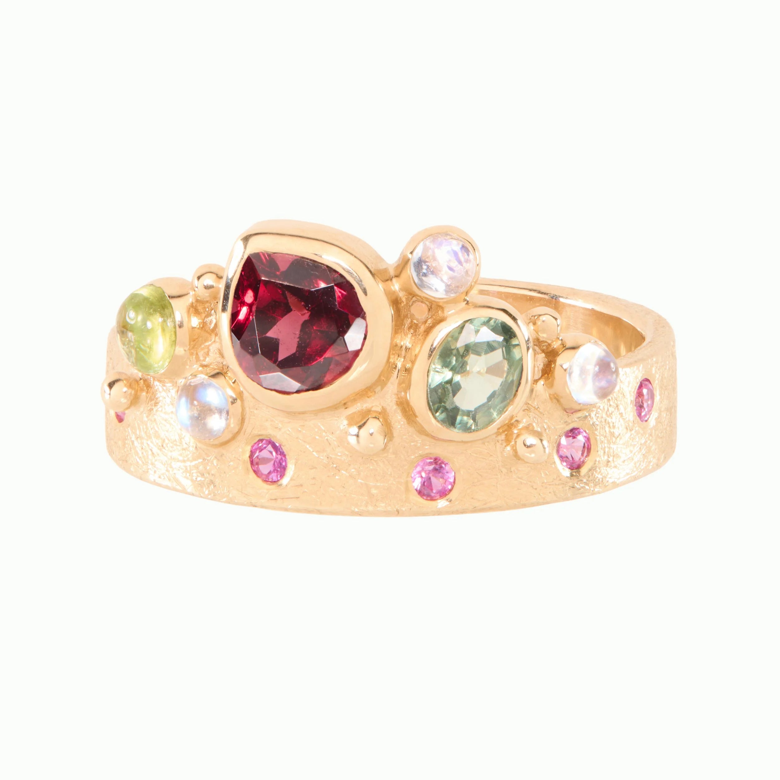 Gold ring with multicolored gemstones on a white background