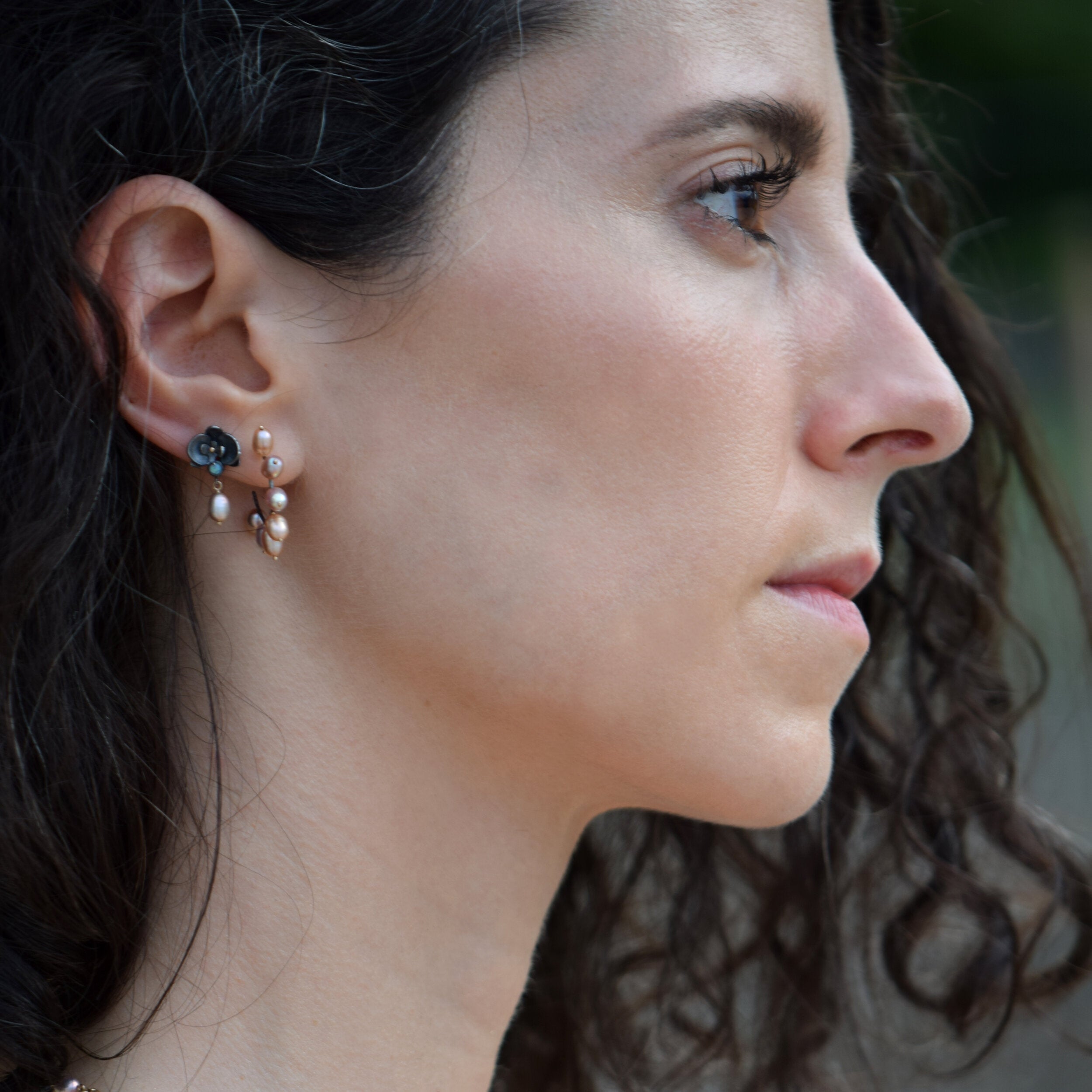 Close-up of a woman wearing earrings with a blurred background