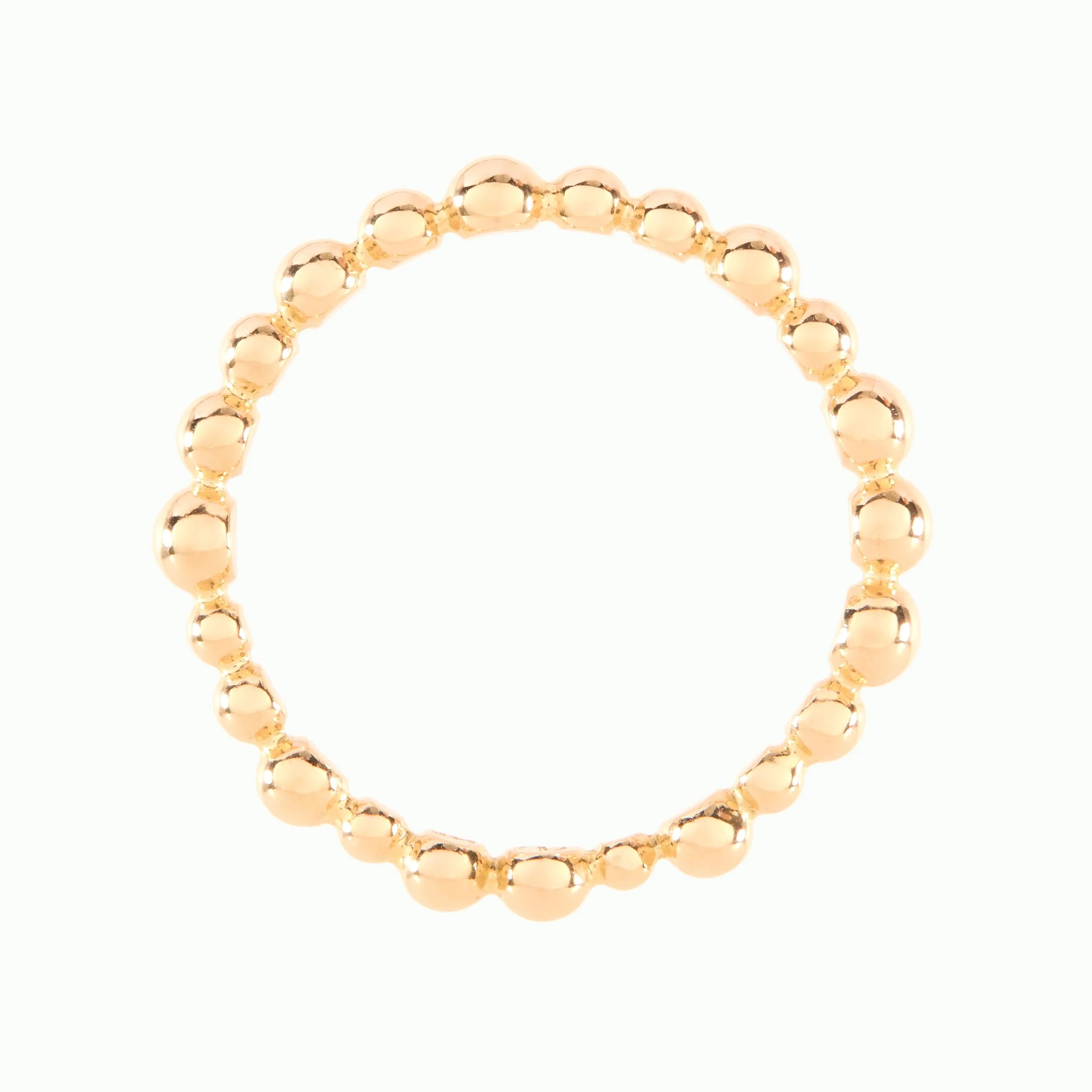 Gold beaded ring on a white background