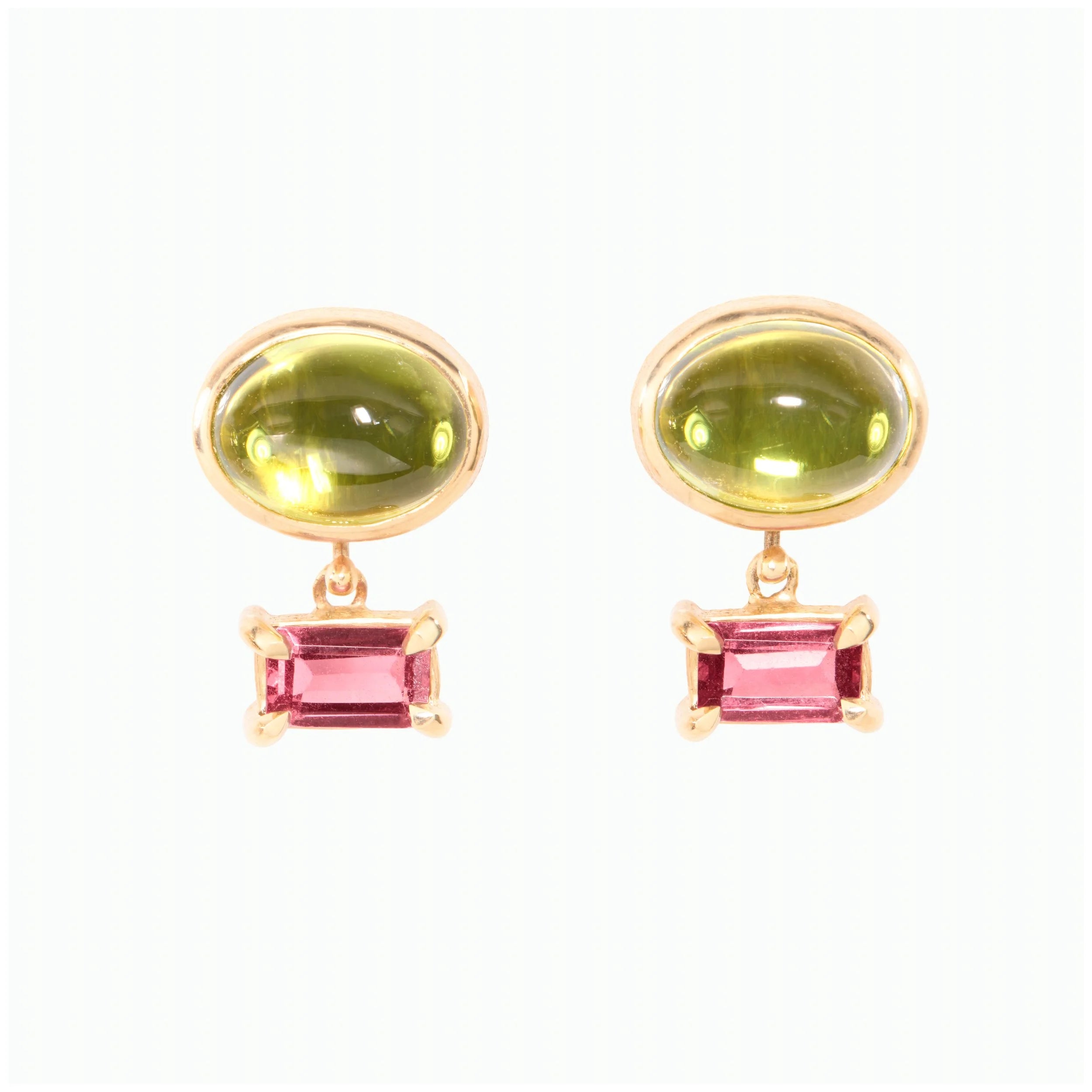 Pair of earrings with green and purple gemstones on a white background