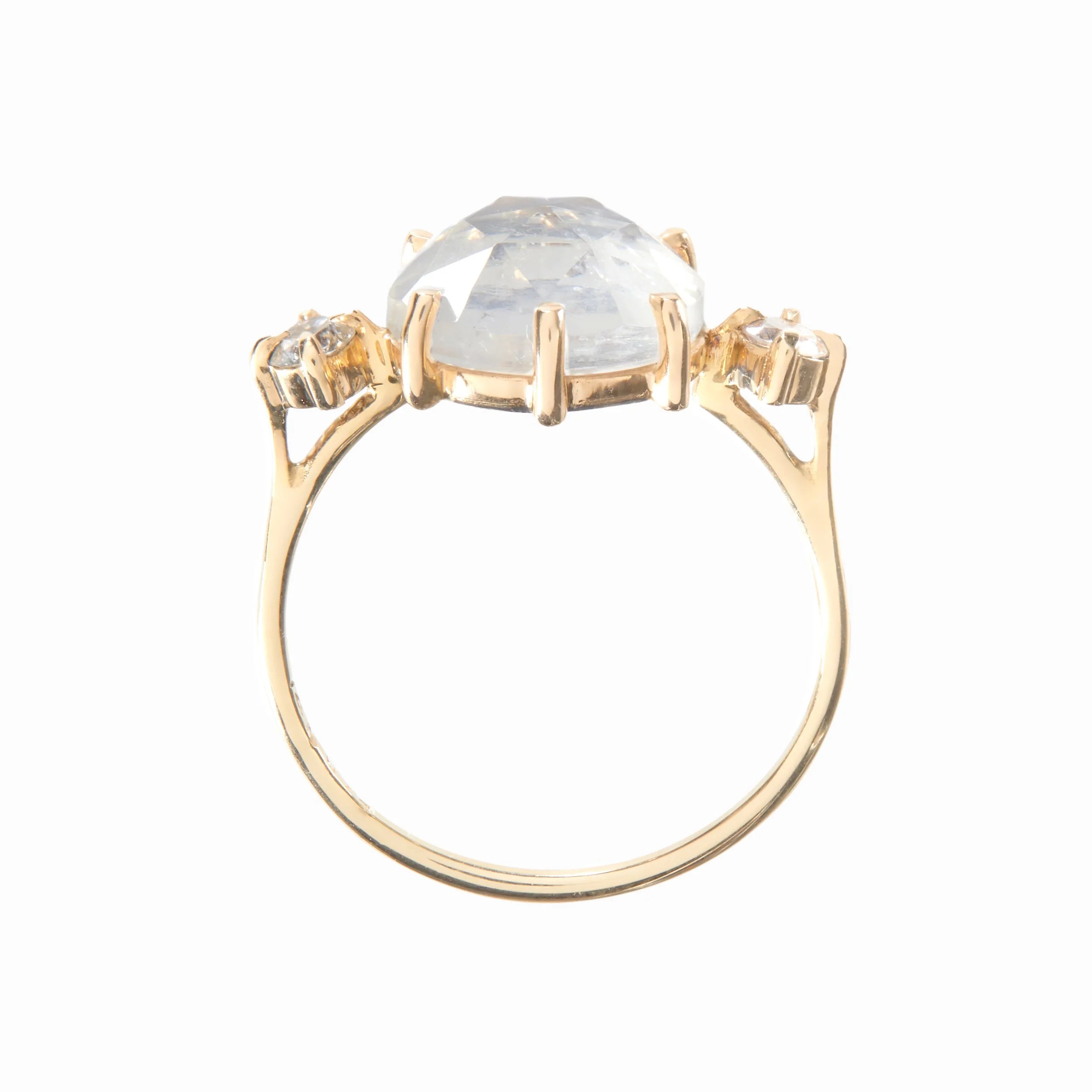 Gold ring with a large central gemstone and smaller stones on a white background