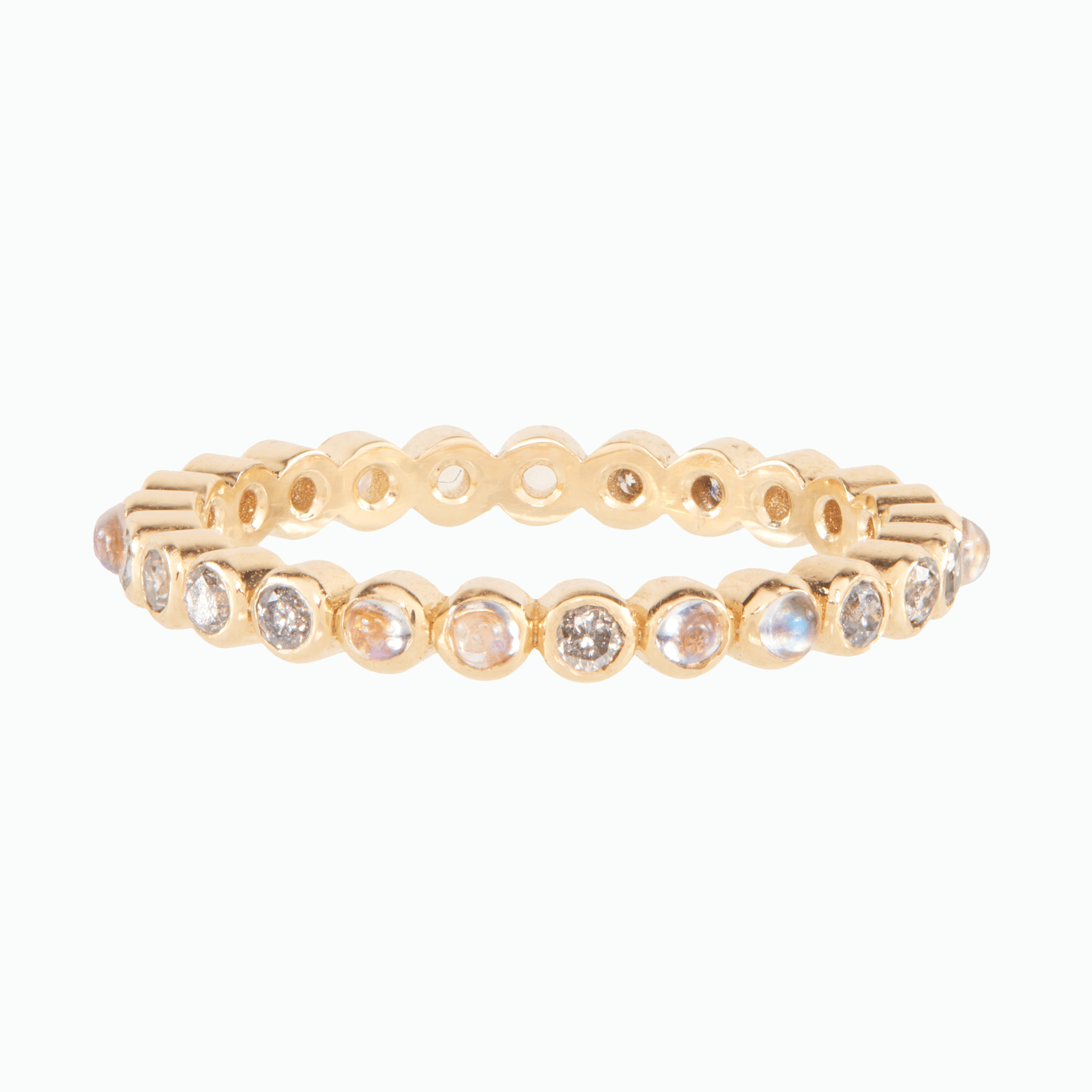 Diamond and moonstone gold eternity ring on white background