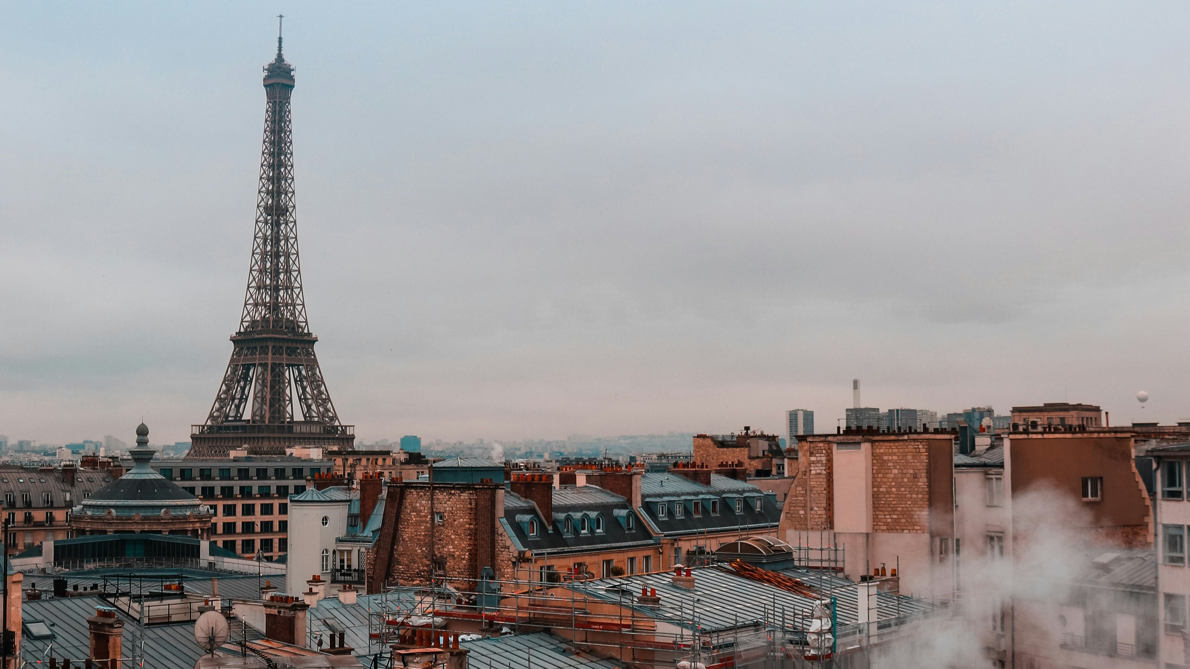 Cityscape of Paris rooftops and Eiffel Tower in distance