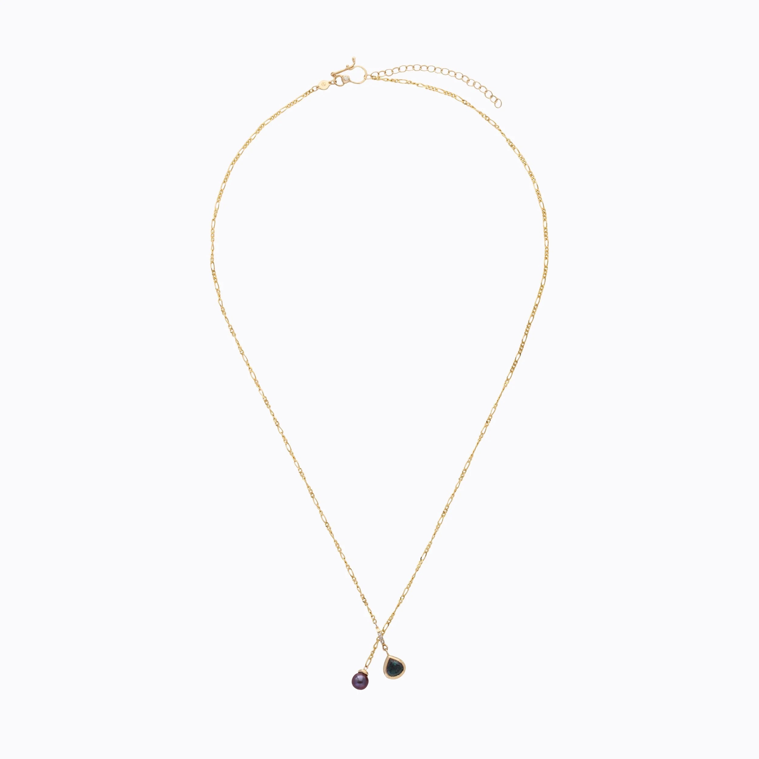 Gold necklace with tear-shaped pendant on a white background