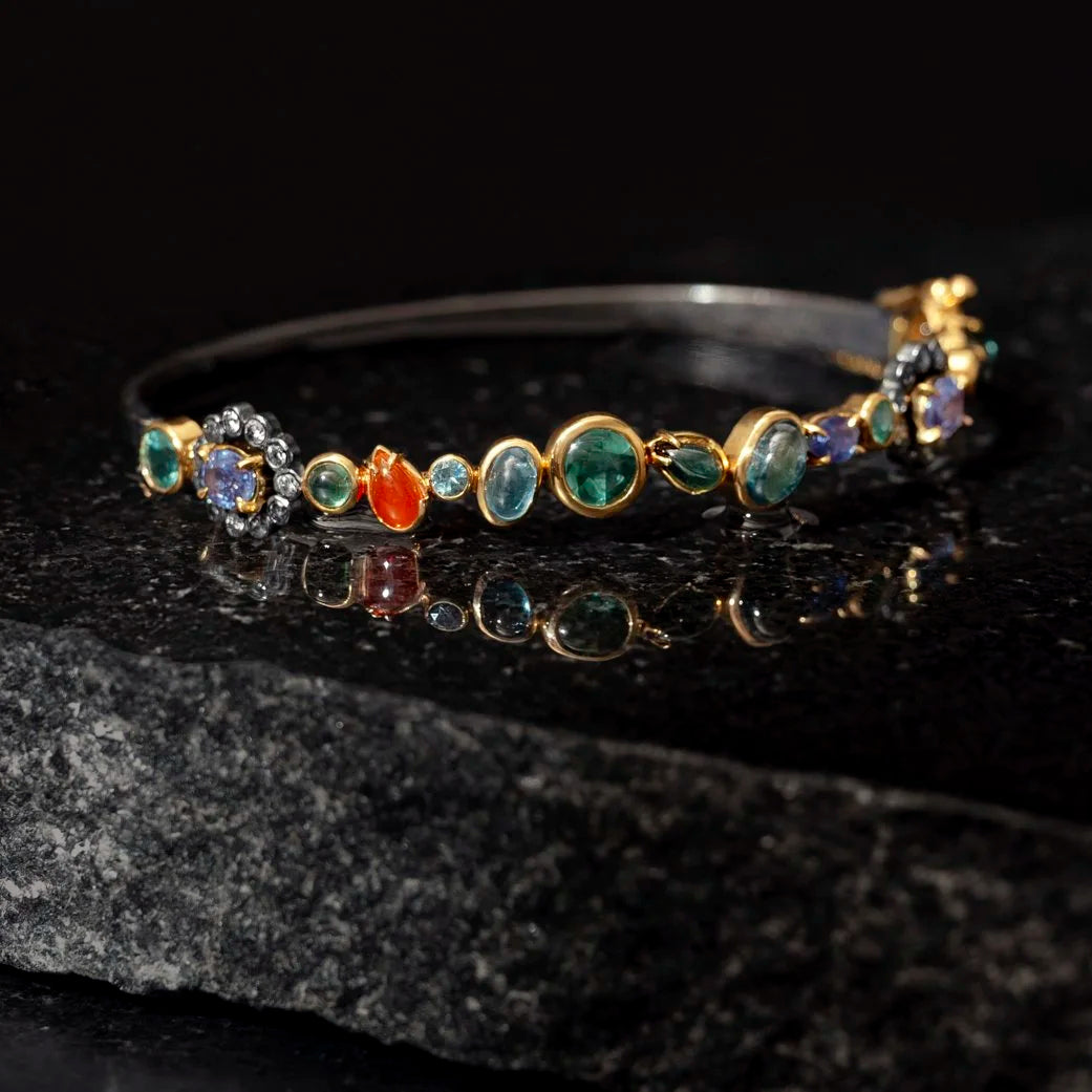 Multicolored gemstone bracelet on a dark stone surface