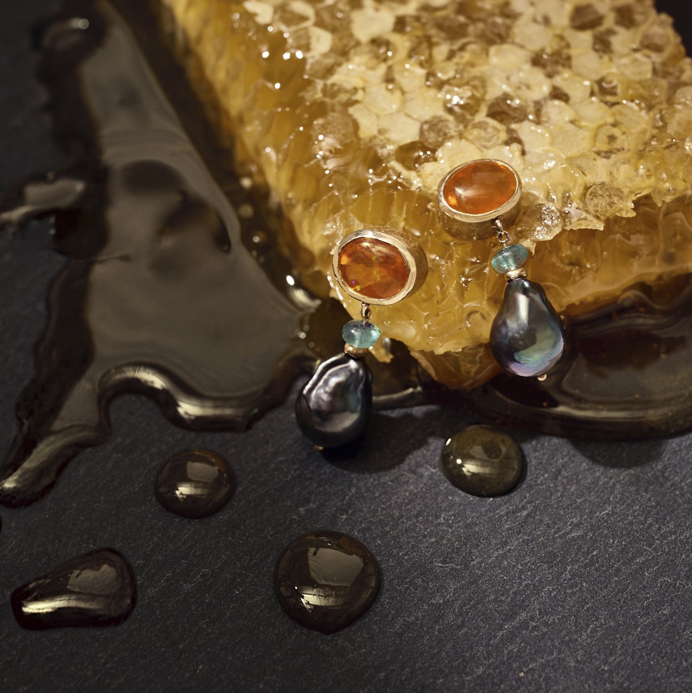 Jewelry with opal and pearl stones on a textured surface