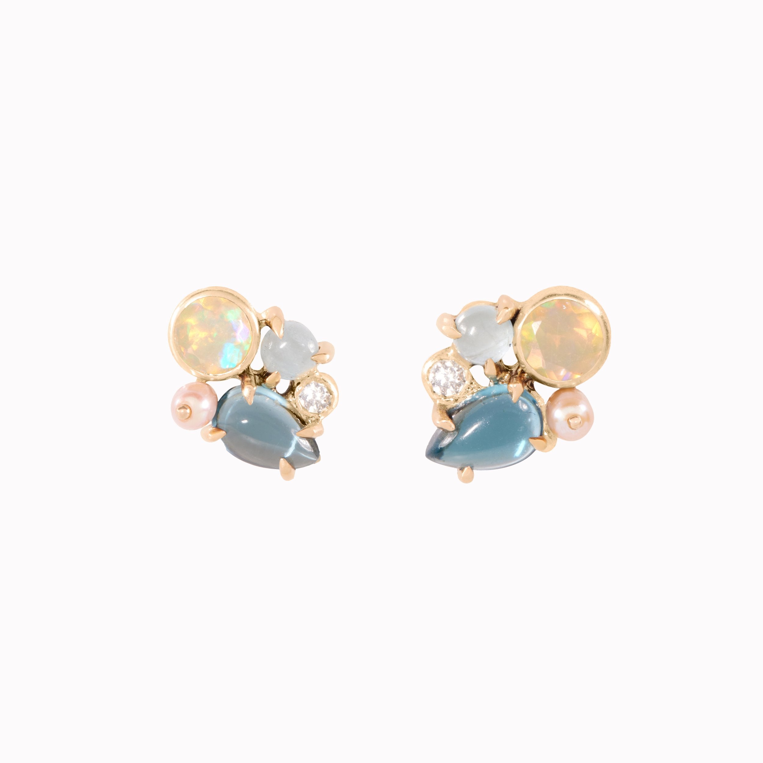 Pair of earrings with multicolored gemstones on a white background