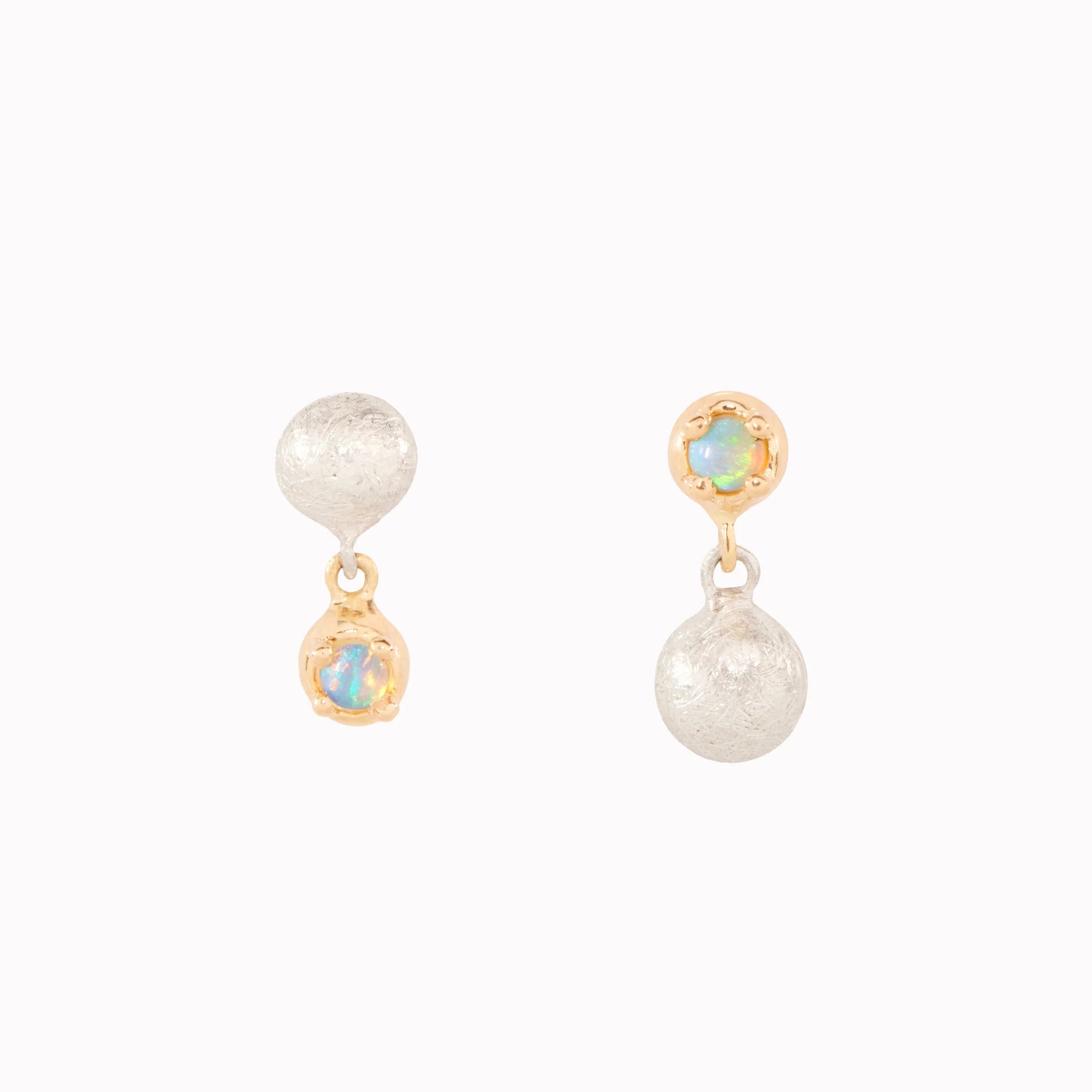 Pair of earrings with opals and gold accents on a white background