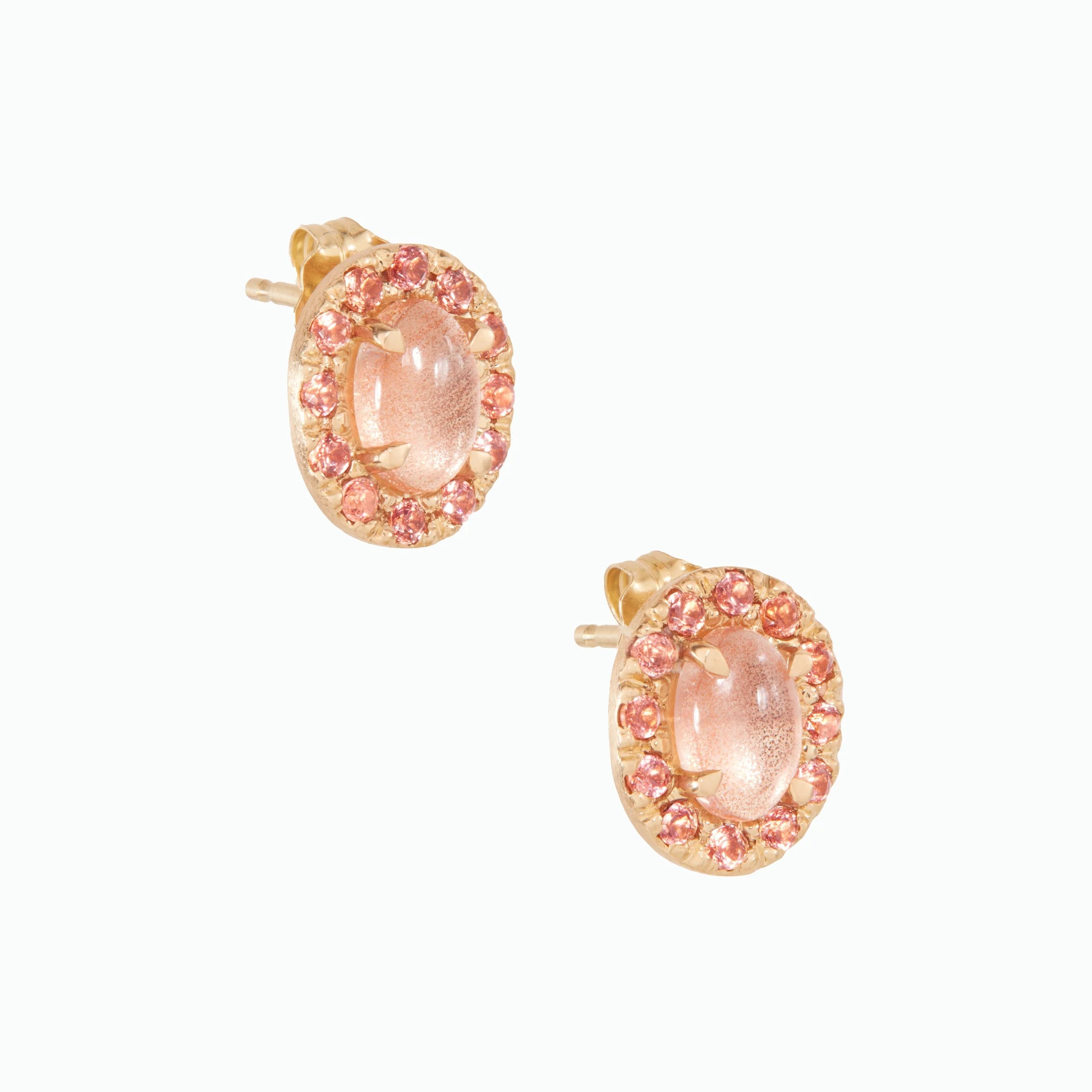 Pair of earrings with pink gemstones on a white background