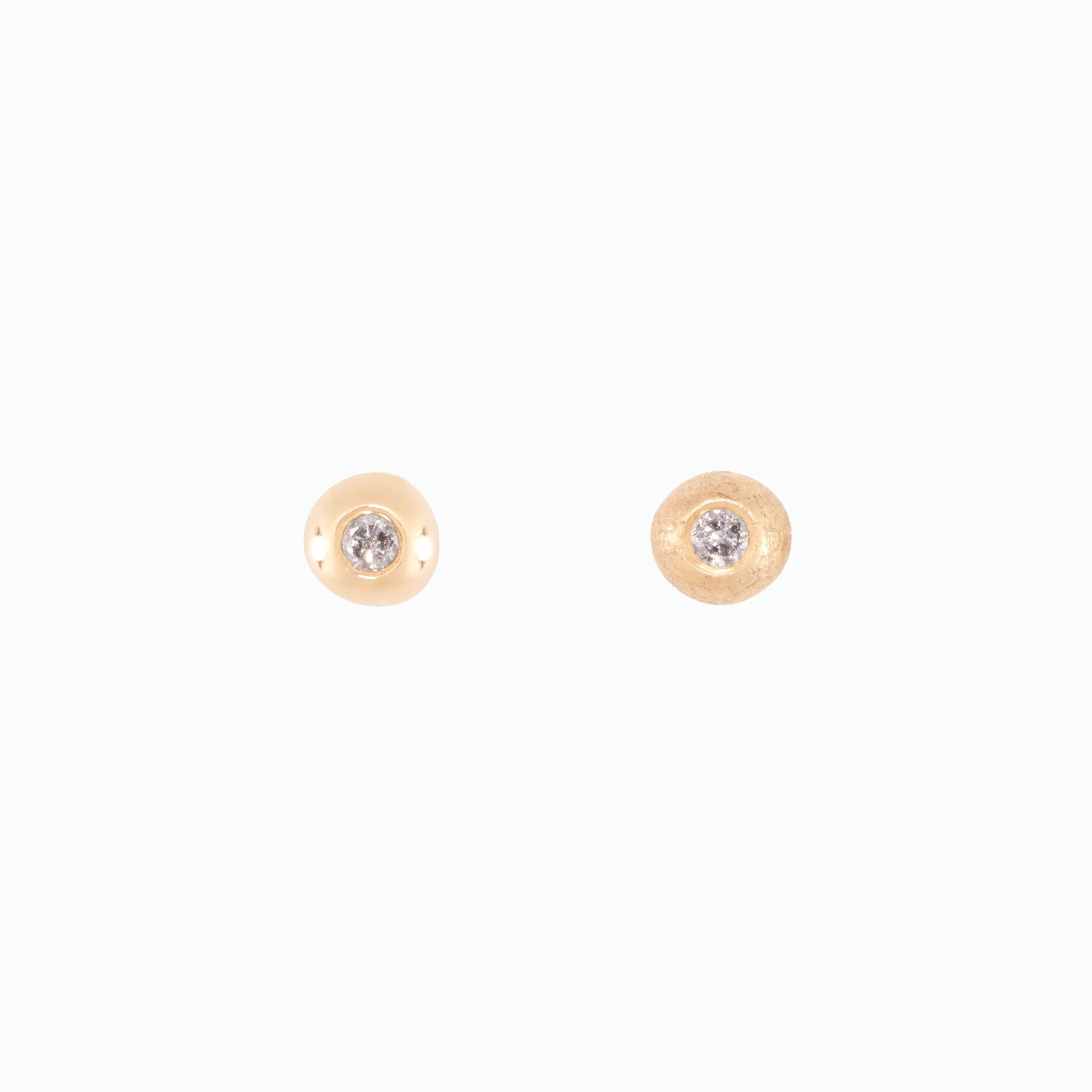 Gold and diamond stud earrings on a white background
