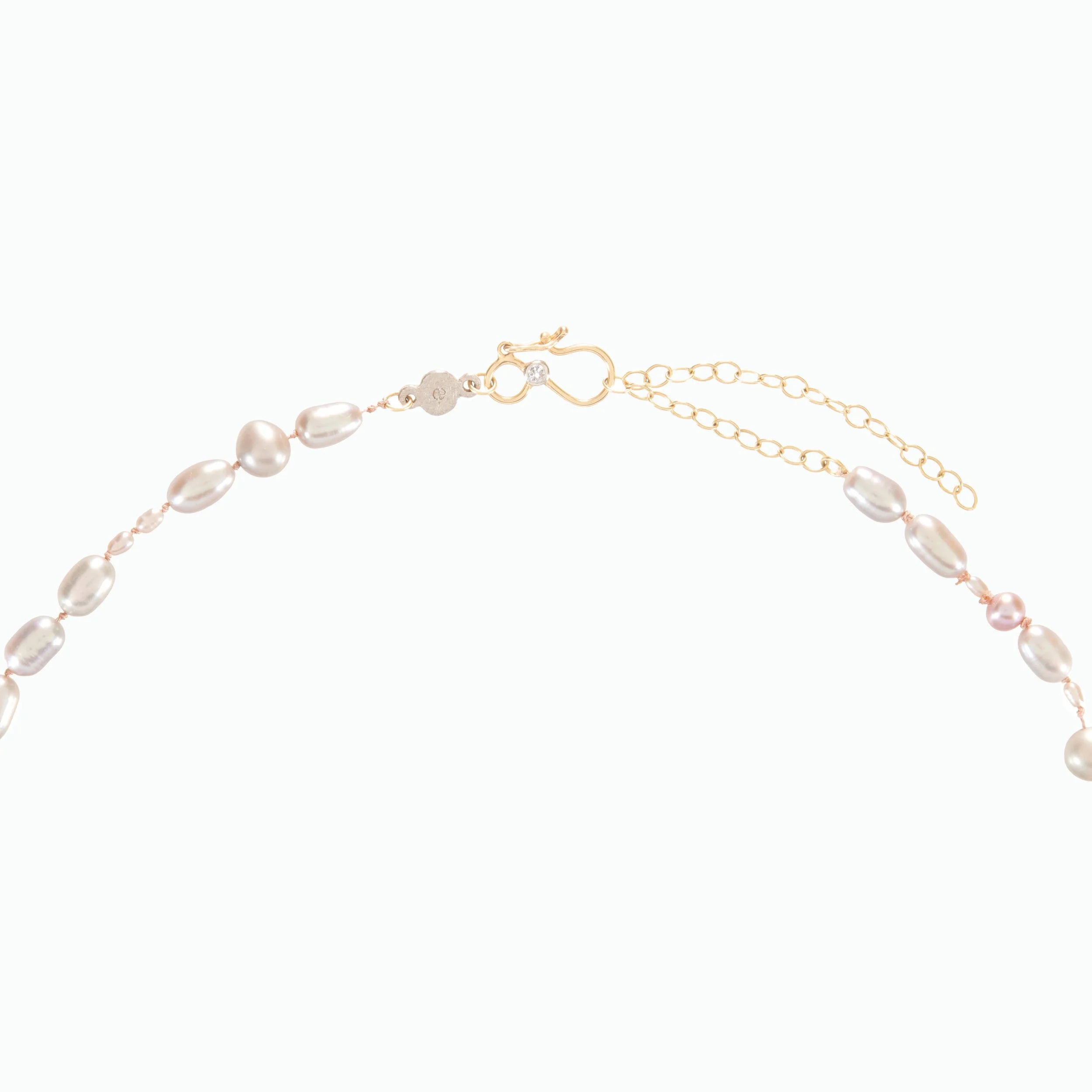 Gold and pearl necklace on a white background