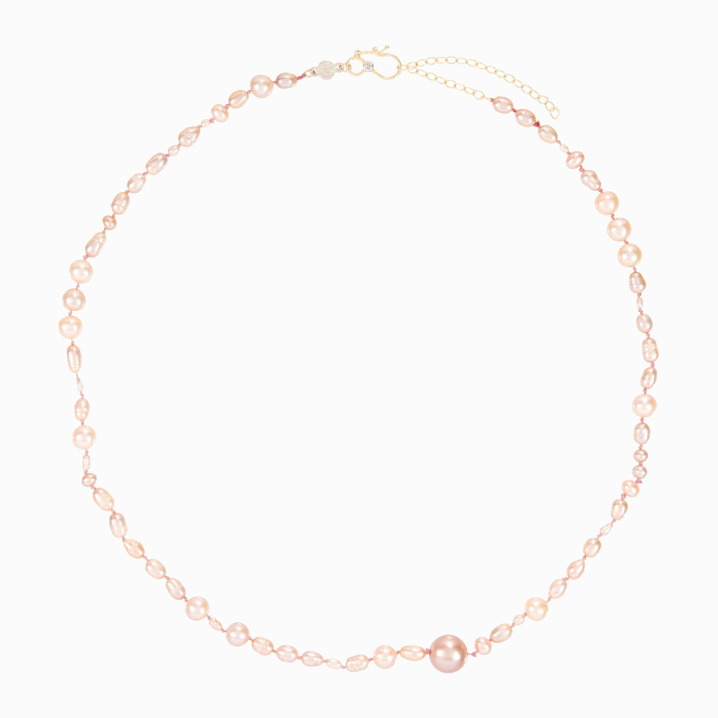 Delicate pearl necklace on a white background