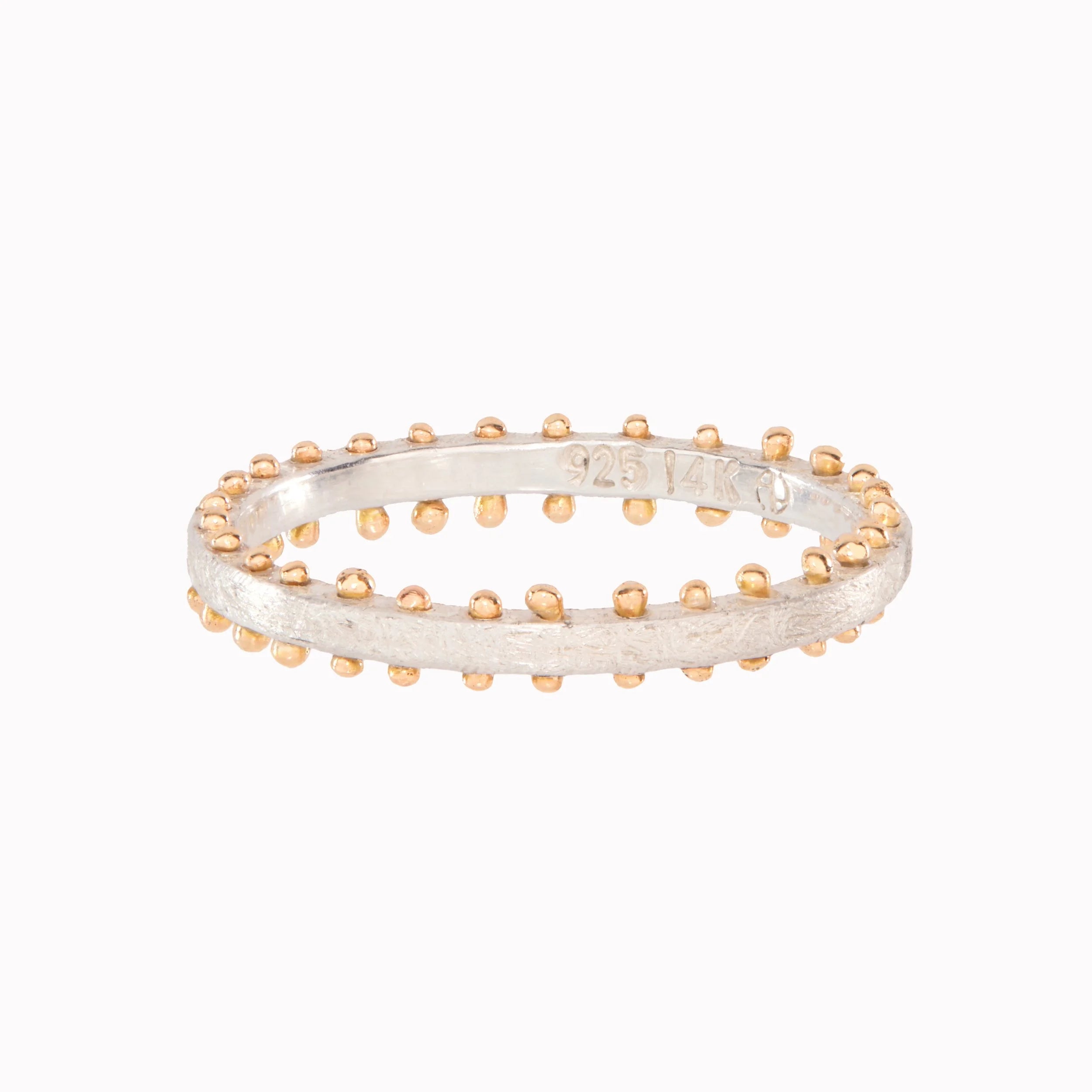 Two-tone gold and silver ring on a white background