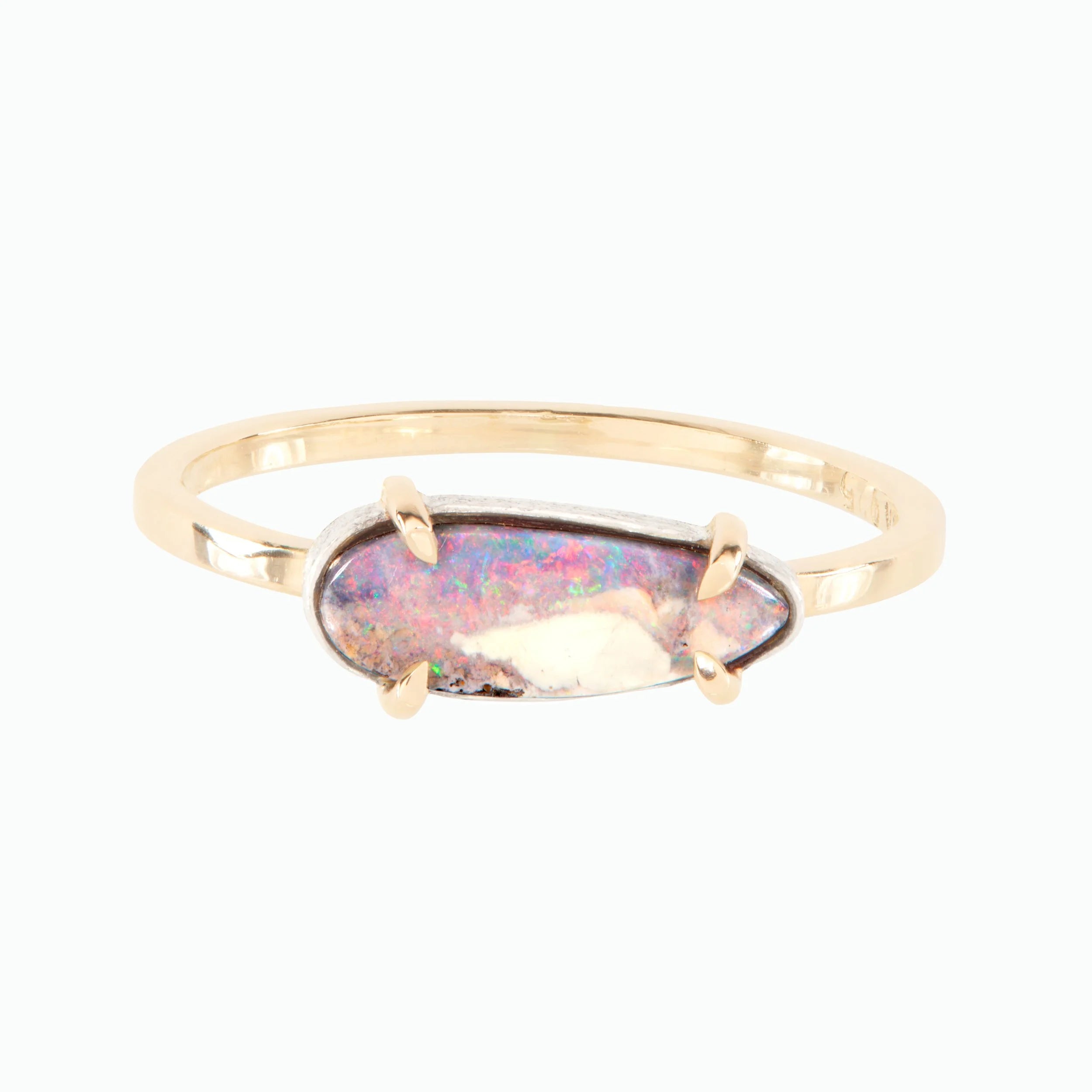 Gold ring with an oval opal stone on a white background