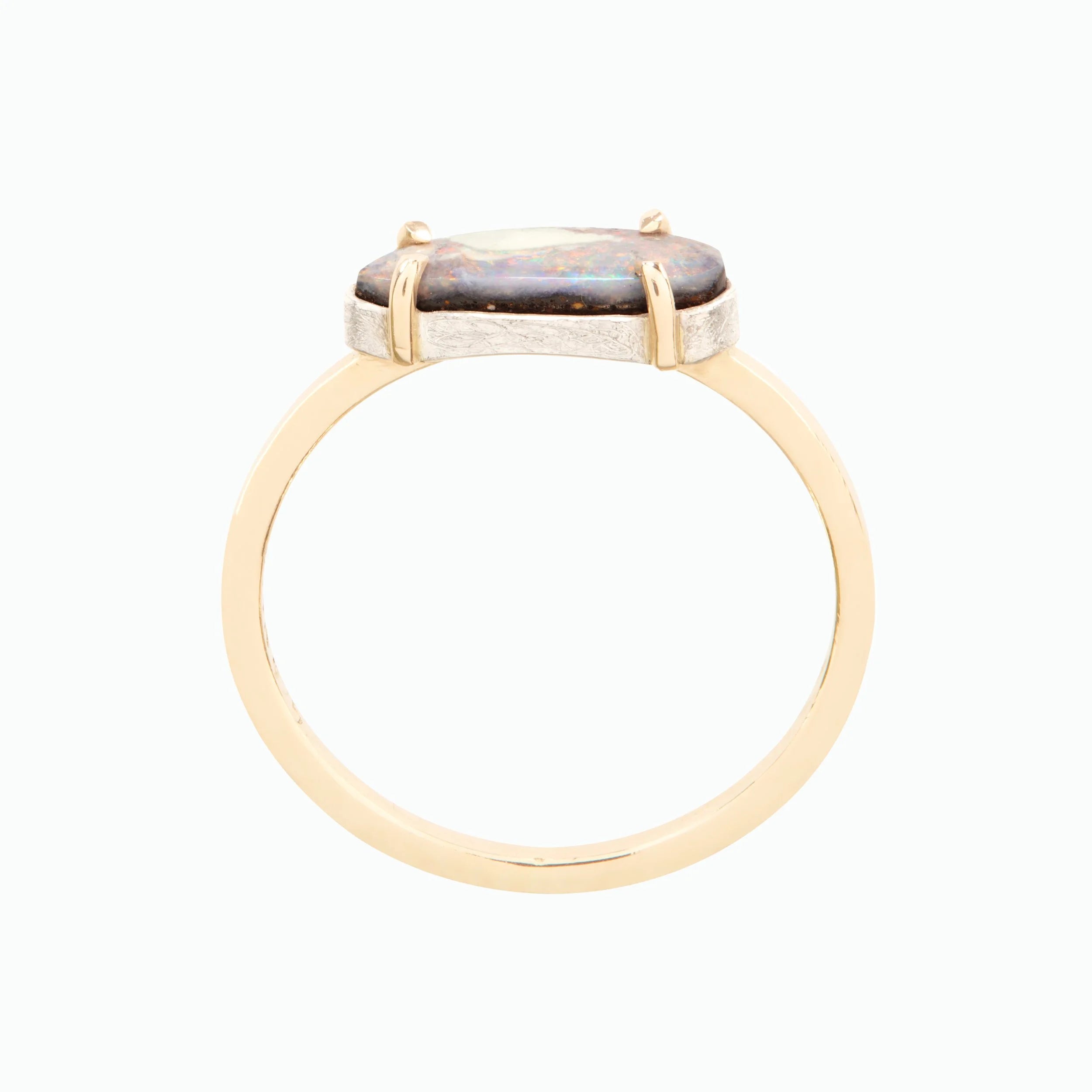 Gold ring with a stone on a white background