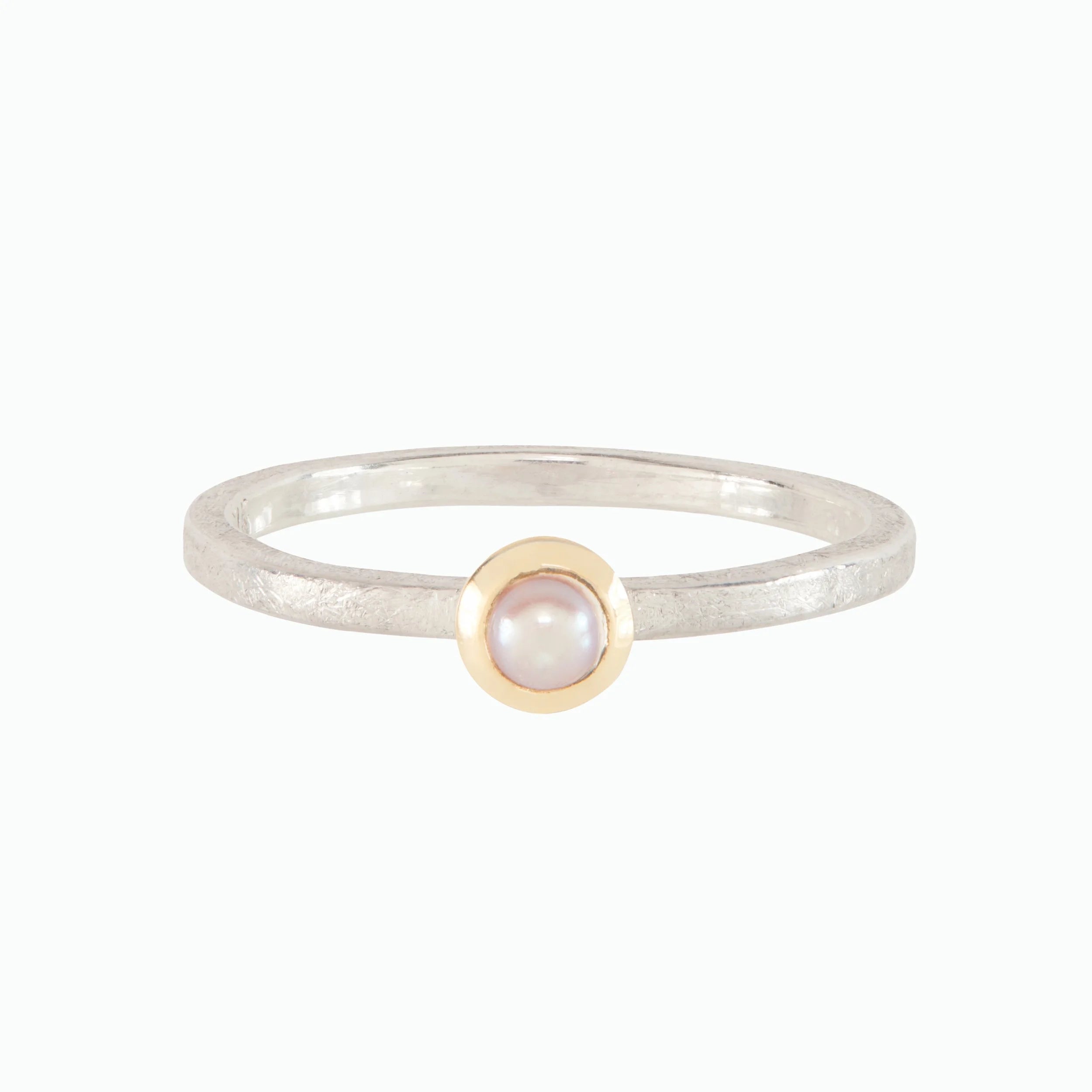 Ring with a pearl and gold accent on a white background
