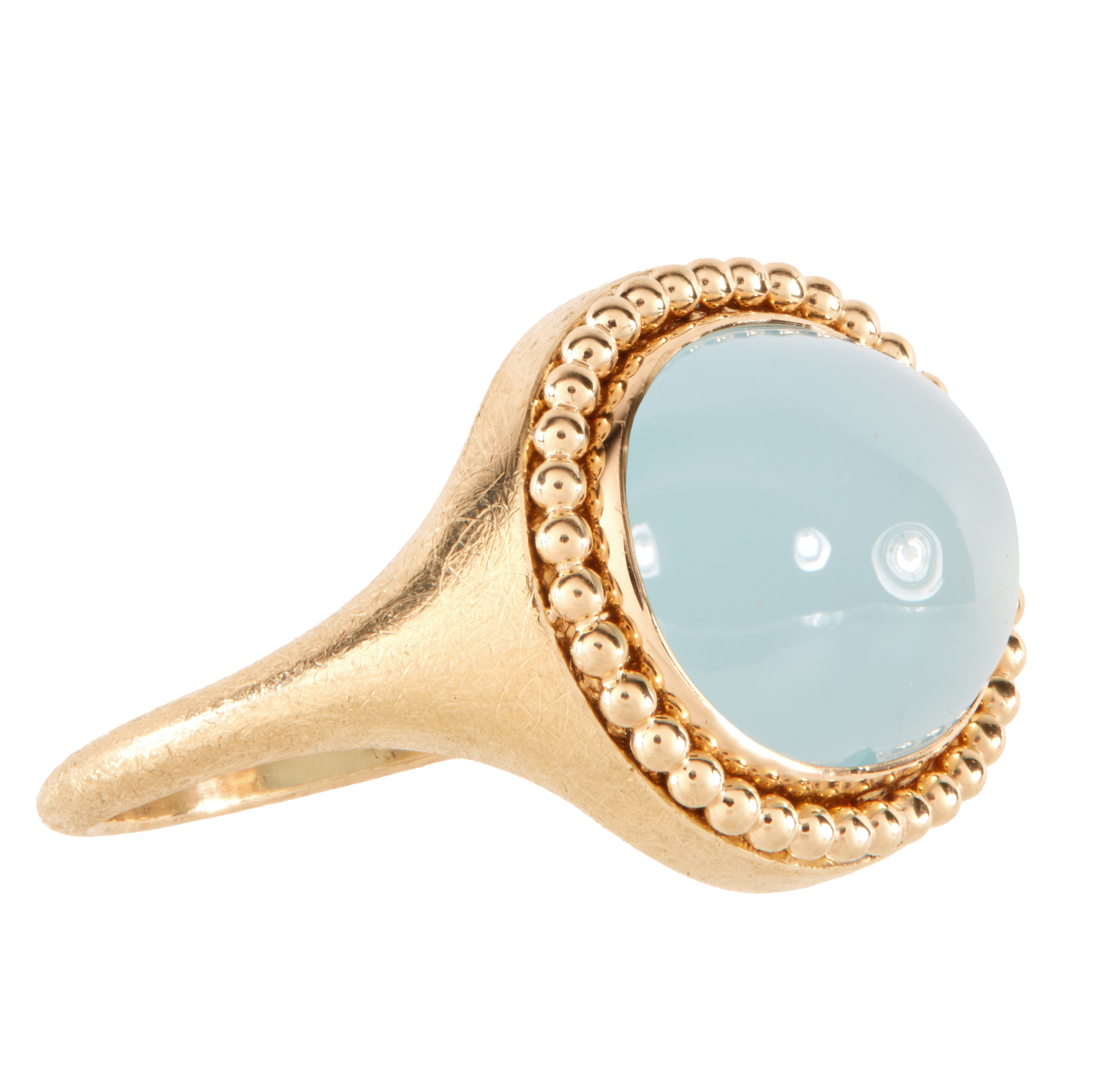 Gold ring with a light blue aquamarine gemstone on a white background