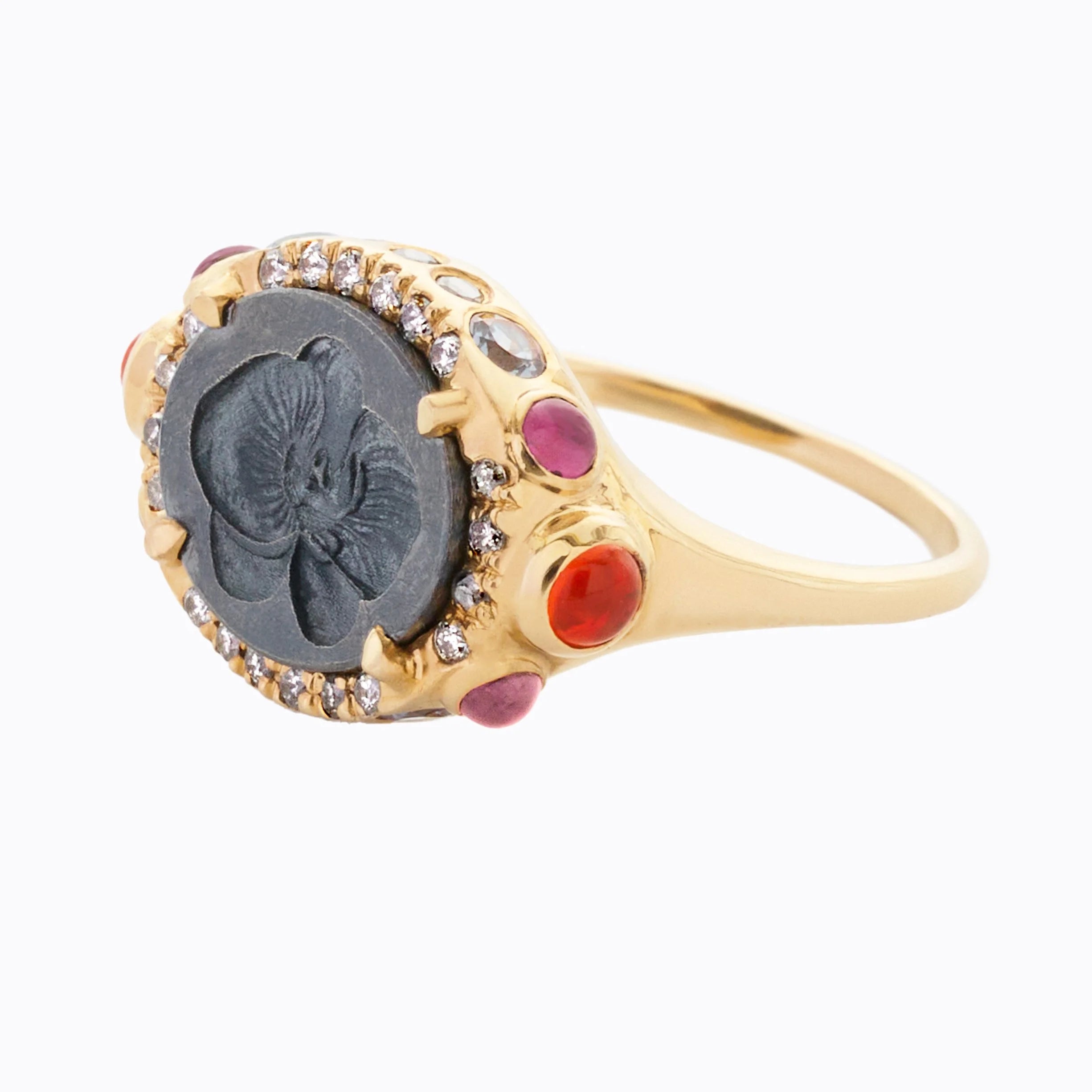 Gold ring with gemstones on a white background