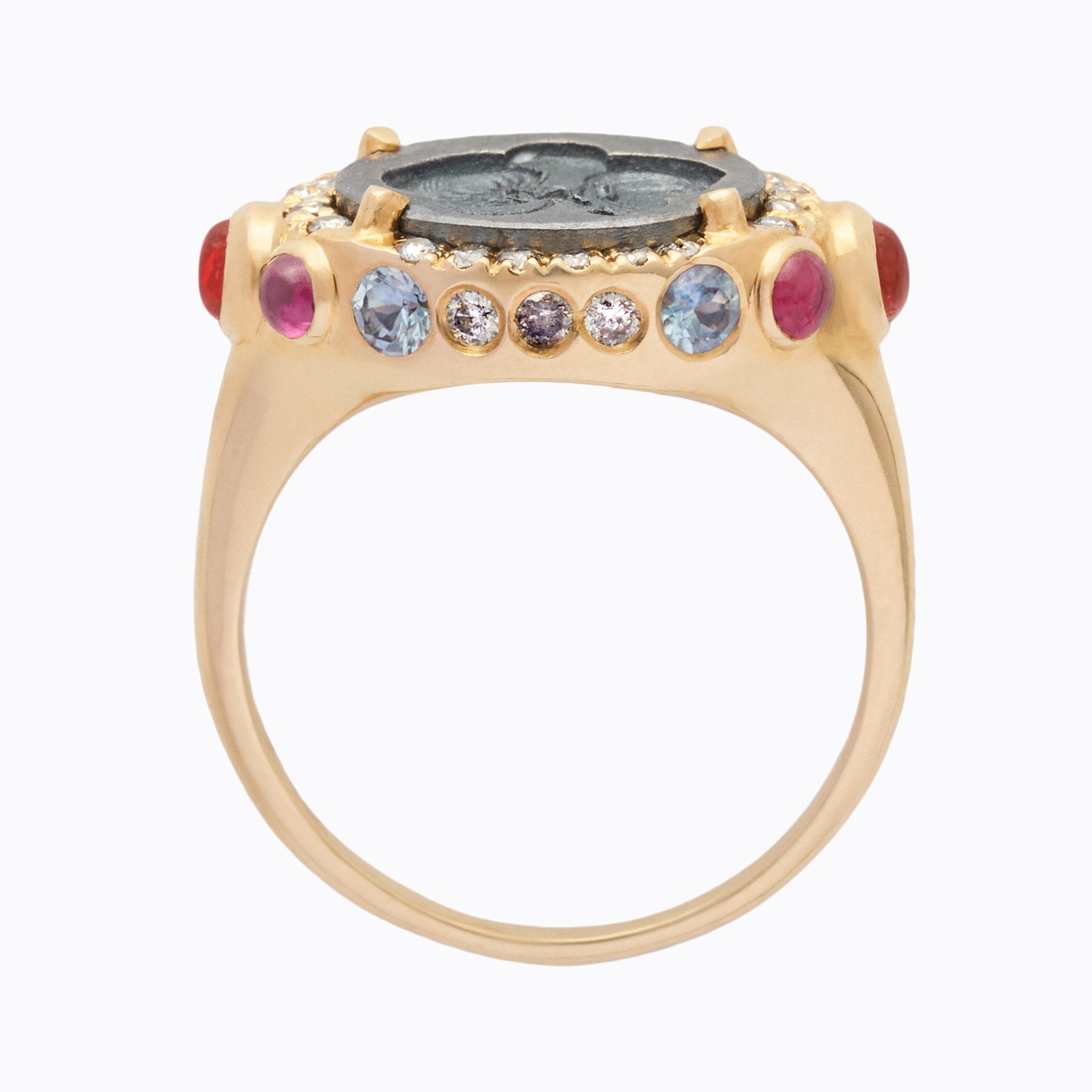 Gold ring with gemstones on a white background