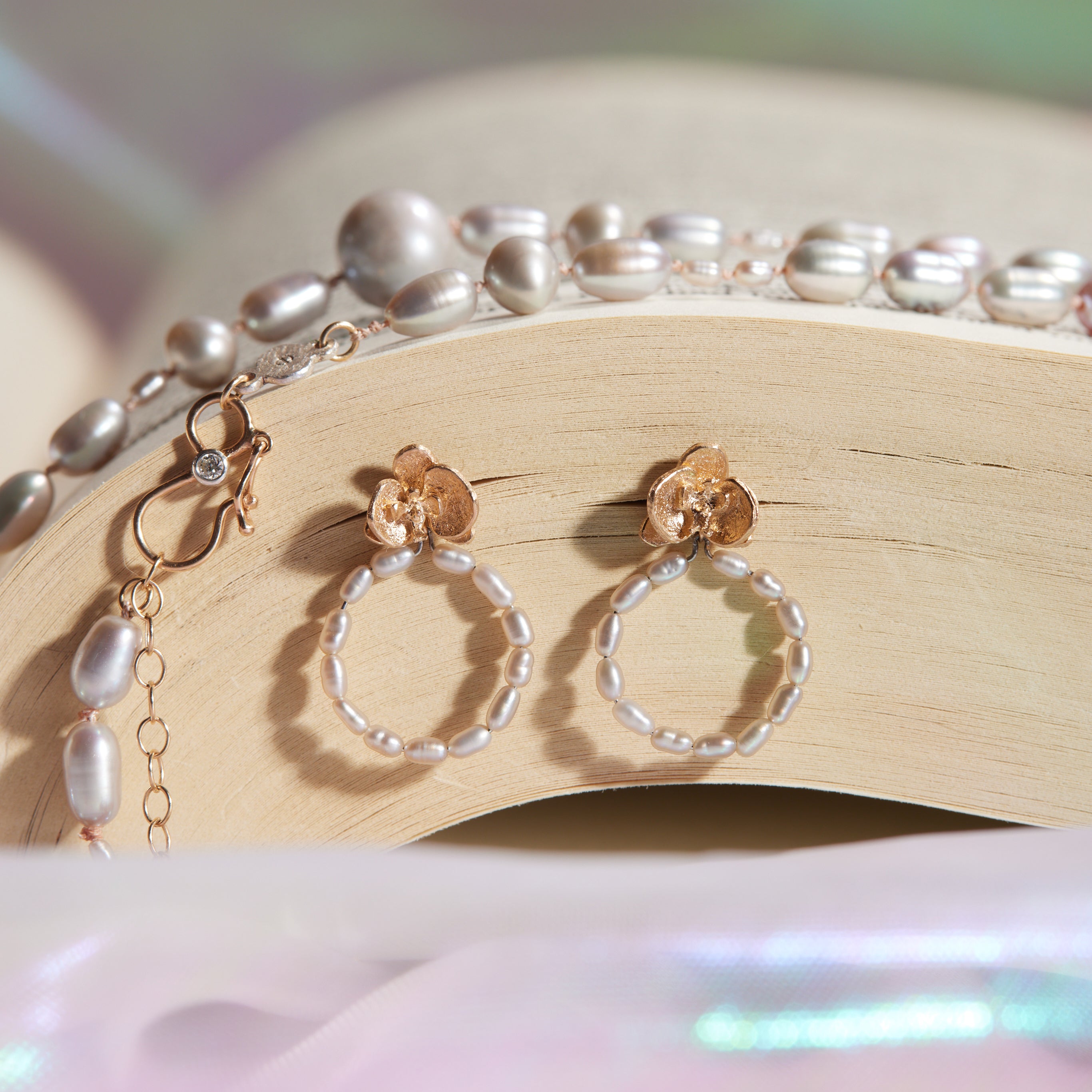 Pair of hoop earrings with pearl accents on book pages