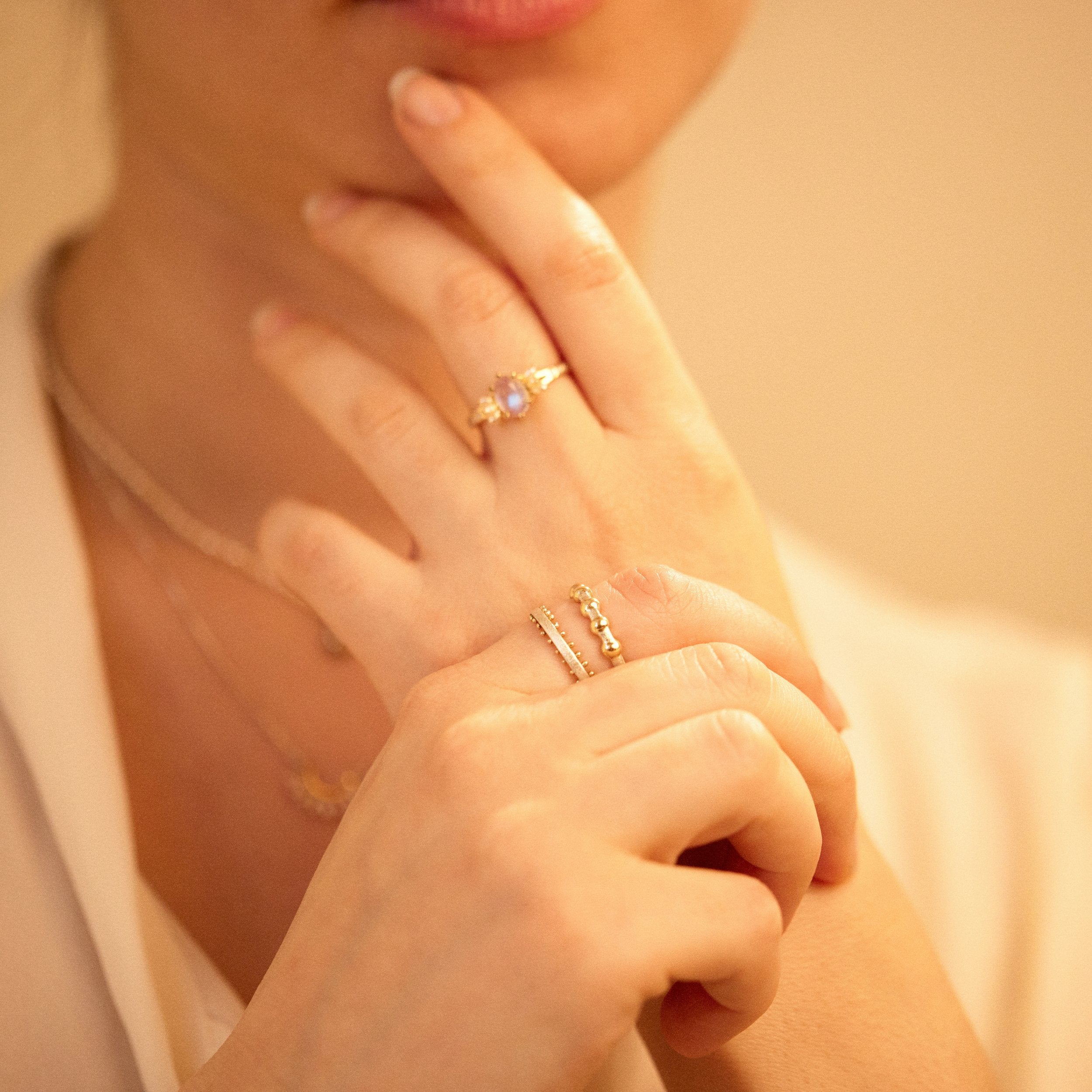 Close-up of hands with gold rings on a soft background