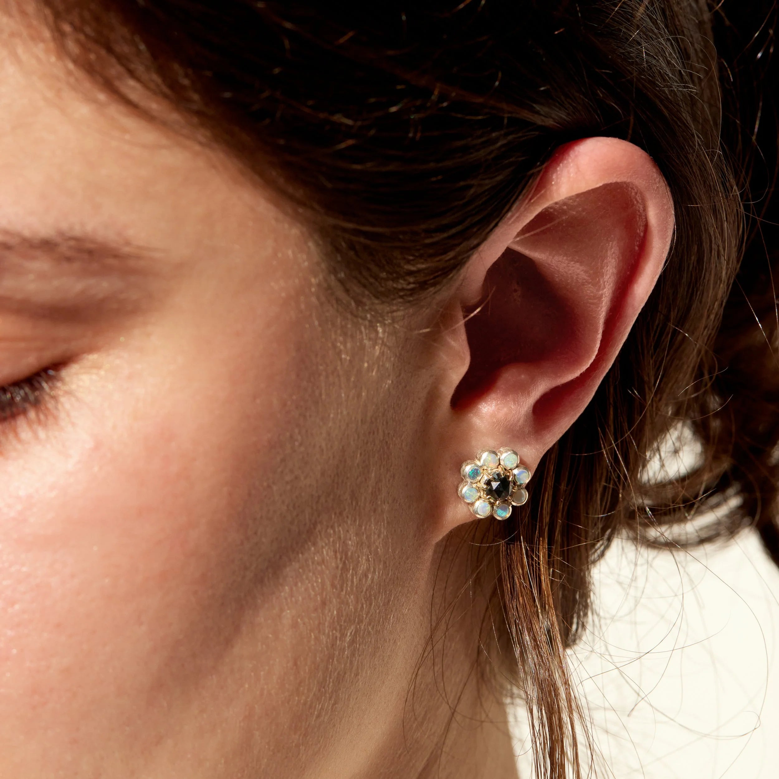 Close-up of a person wearing a floral earring.