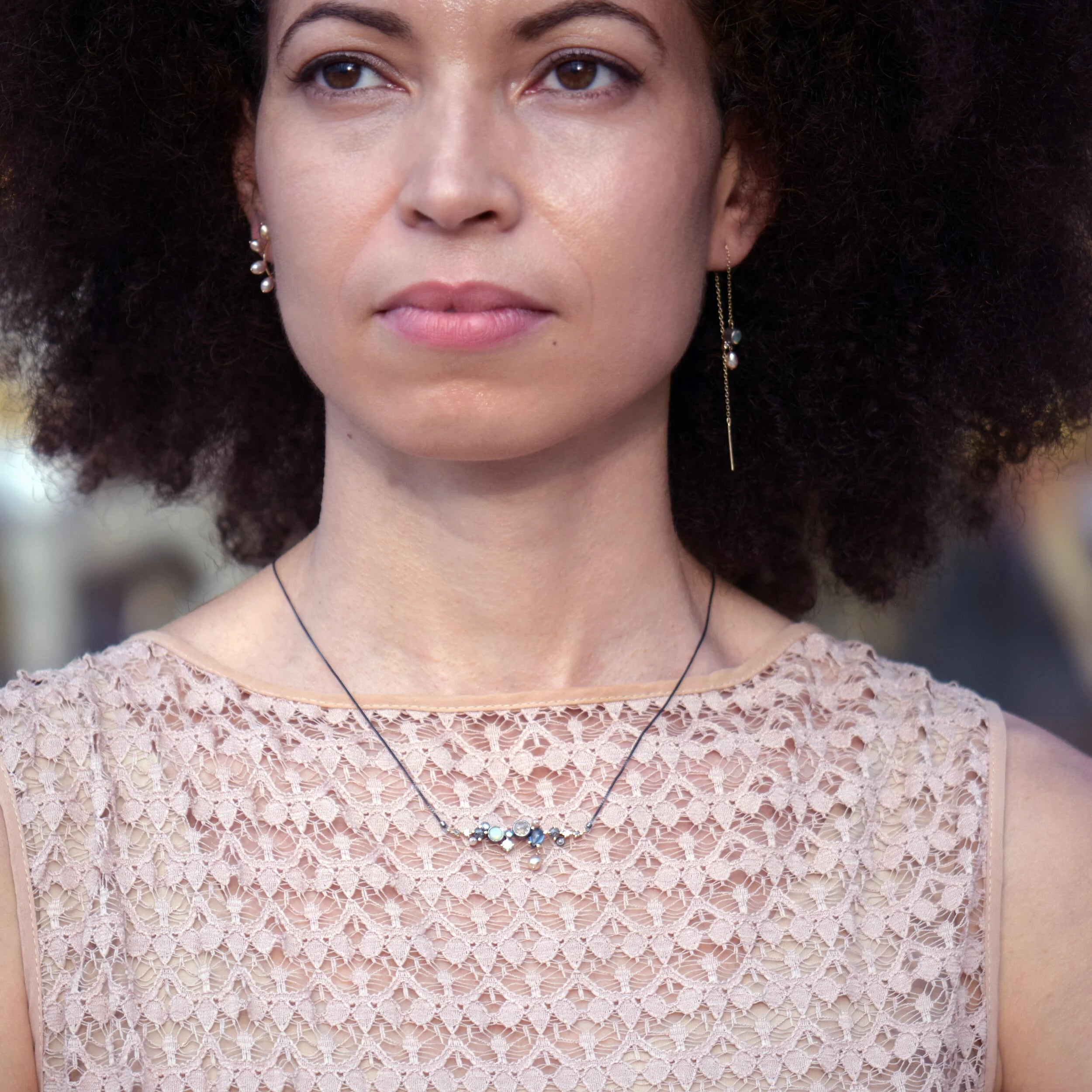 Woman wearing a lace top with a blurred background