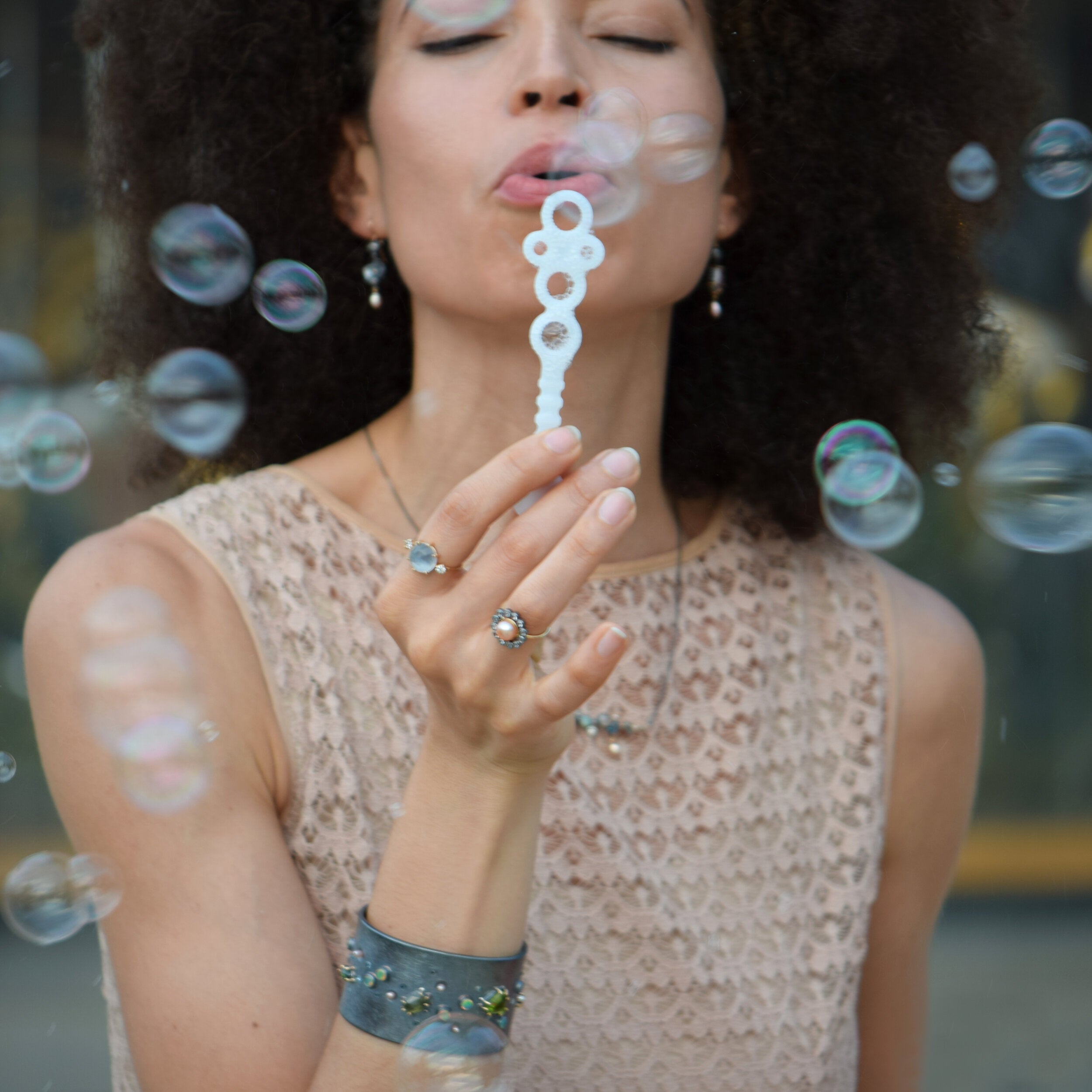 Woman blowing bubbles with a blurred background
