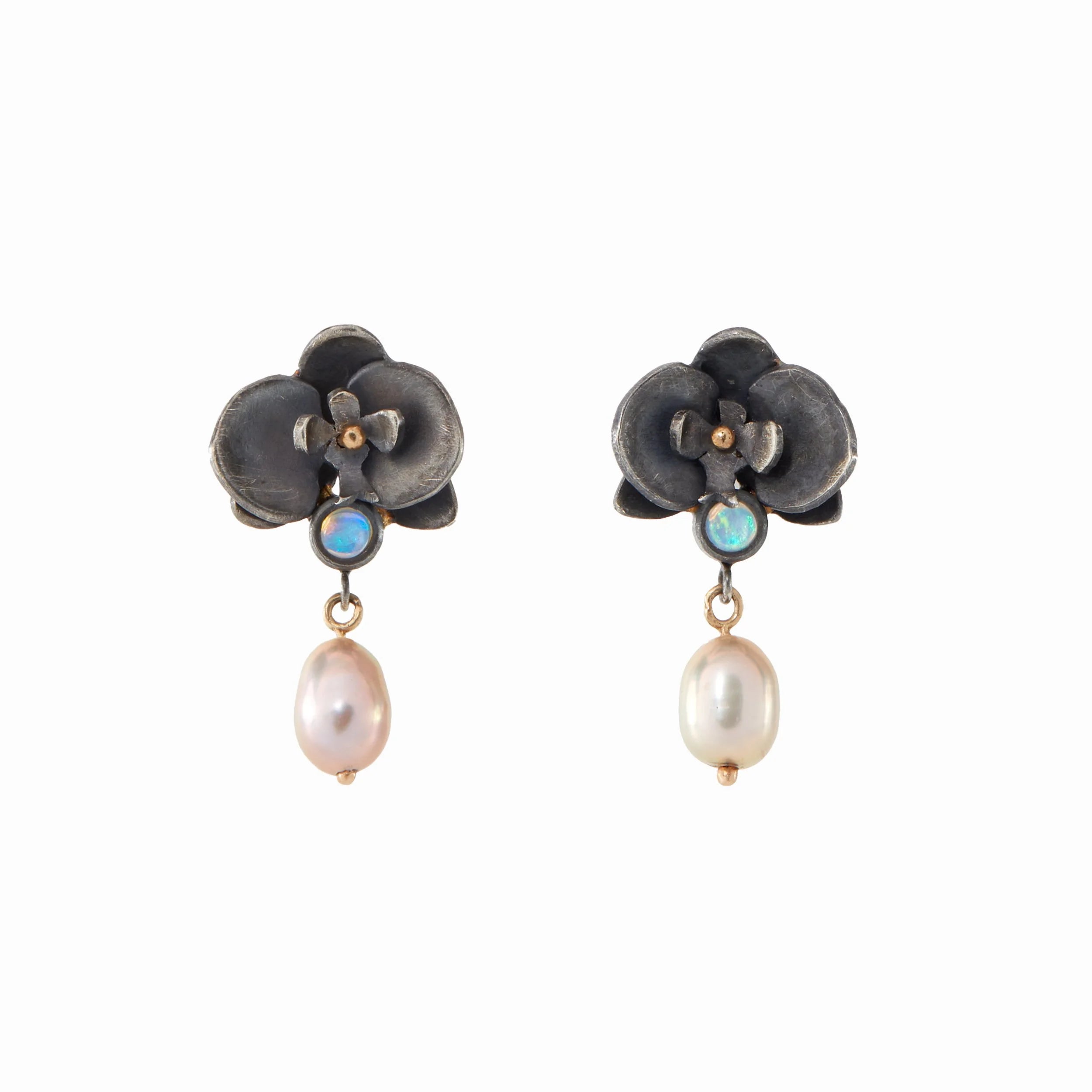 Pair of floral earrings with pearl drops on a white background