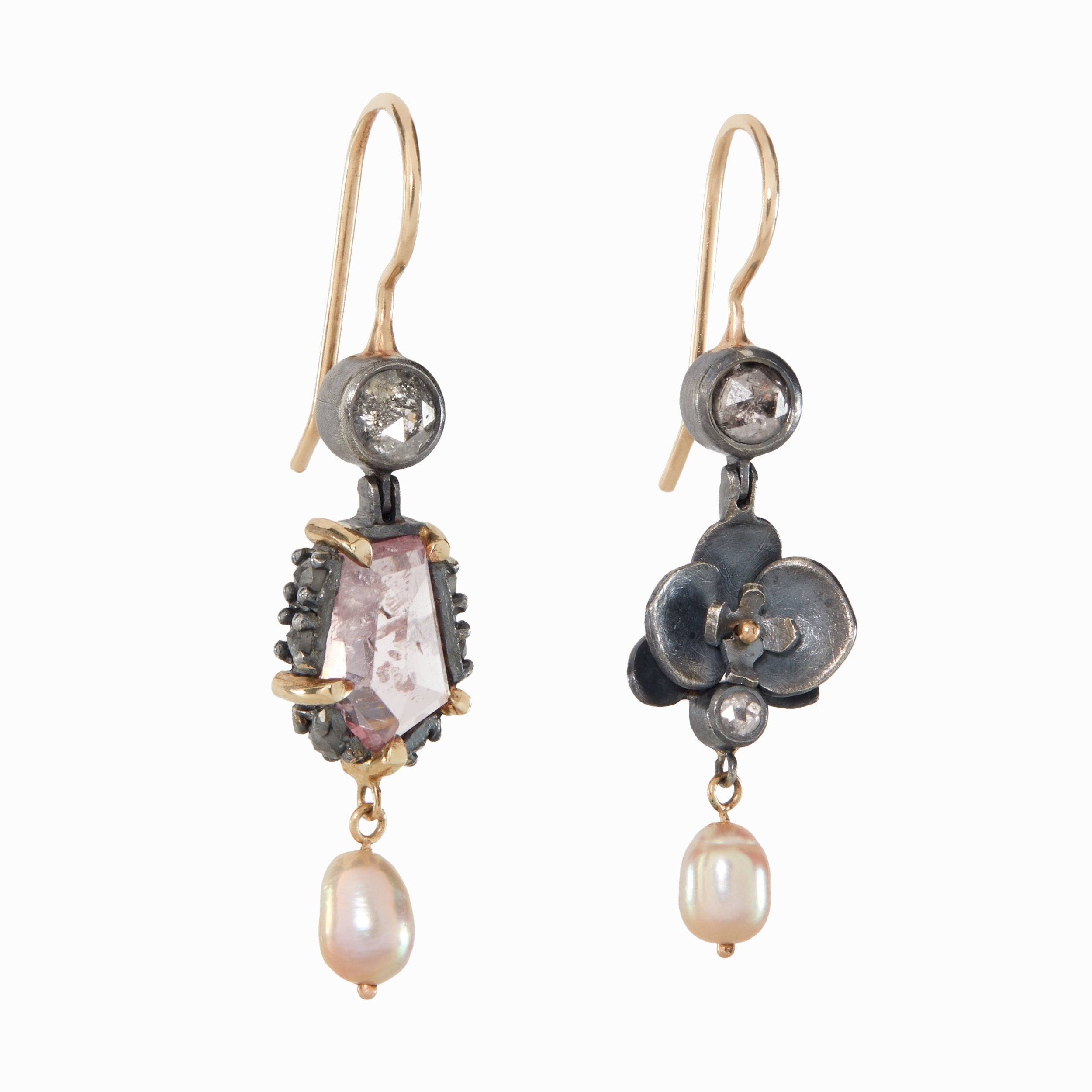 Pair of ornate earrings with gemstones and pearls on a white background