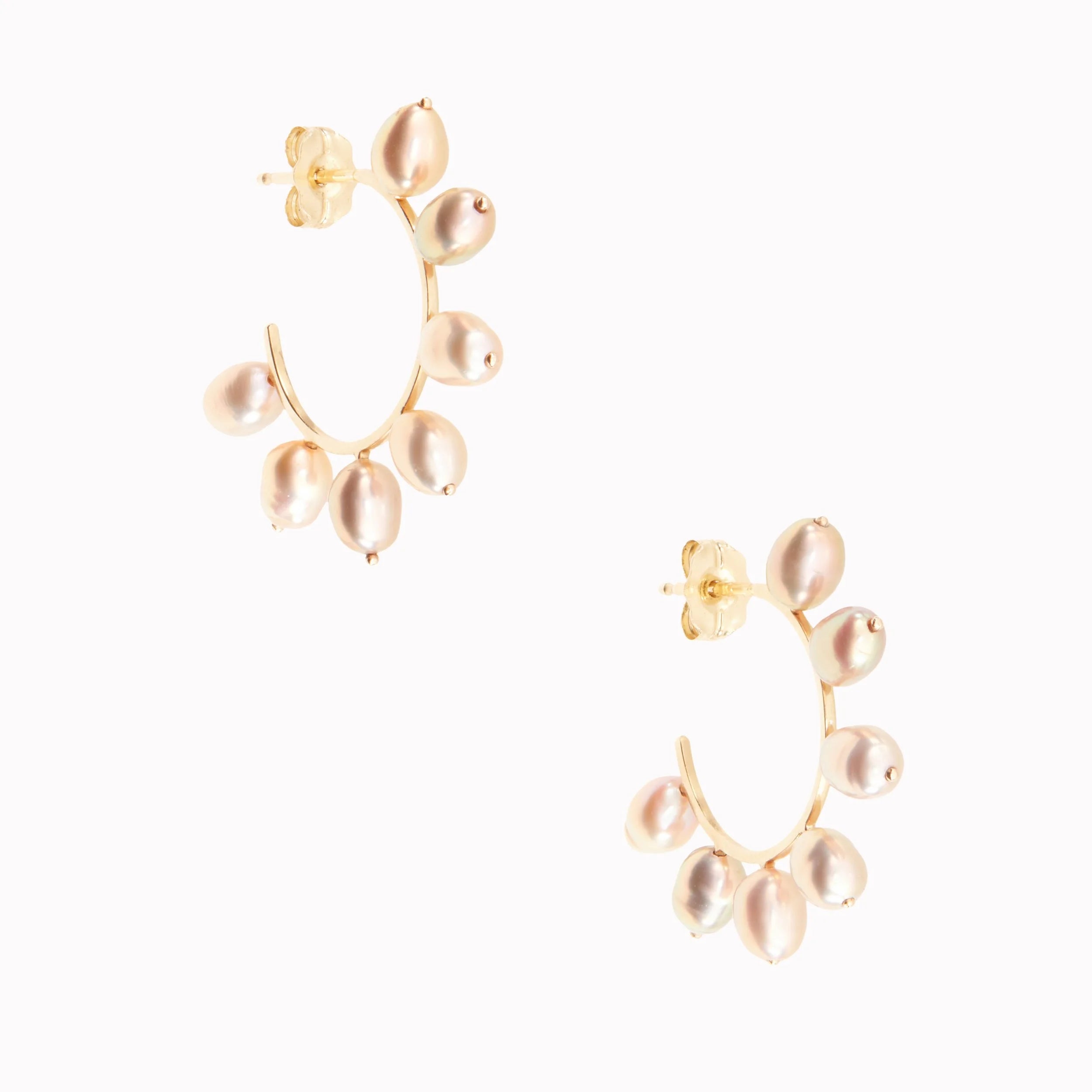 Gold hoop earrings with pearl beads on a white background