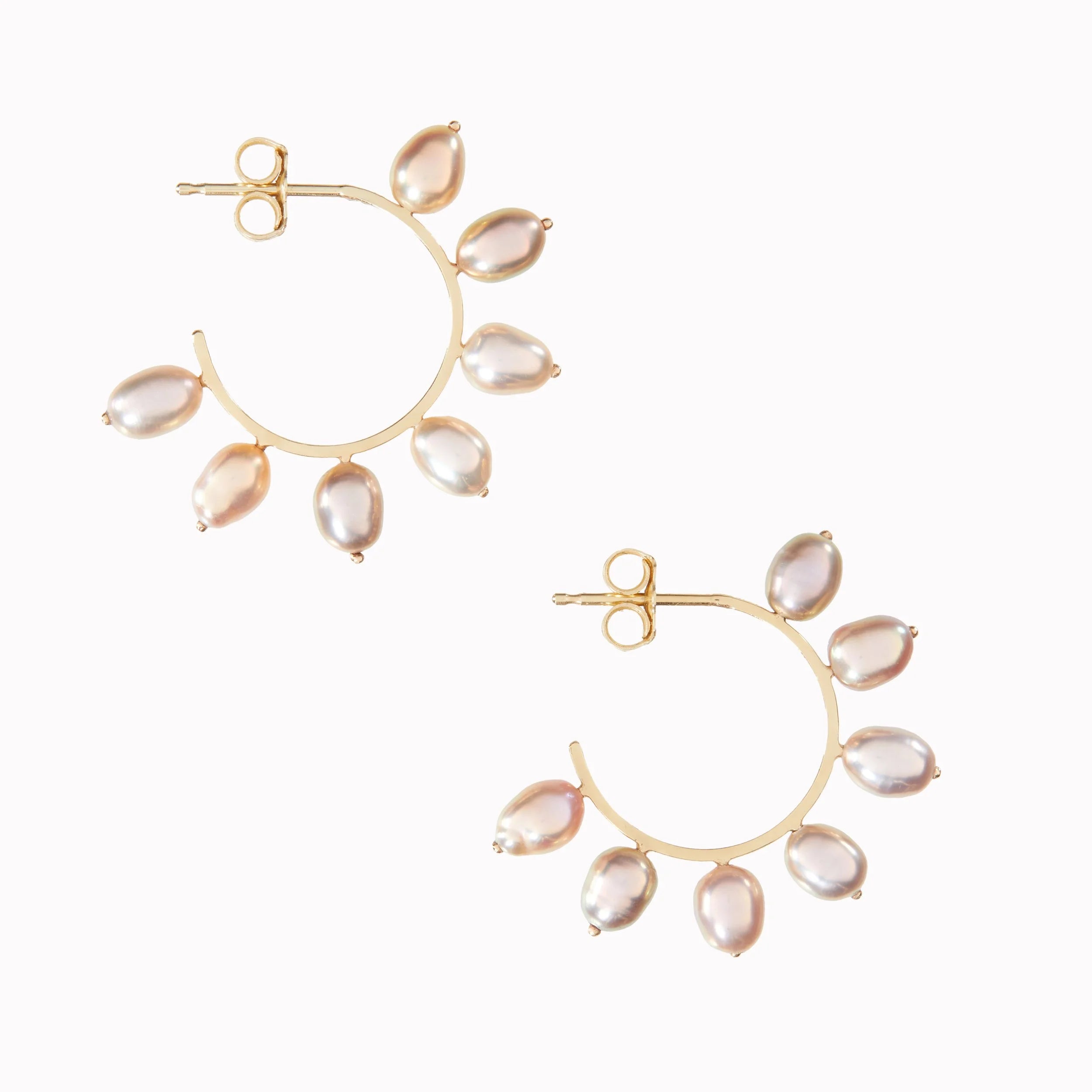 Gold hoop earrings with teardrop-shaped pearls on a white background