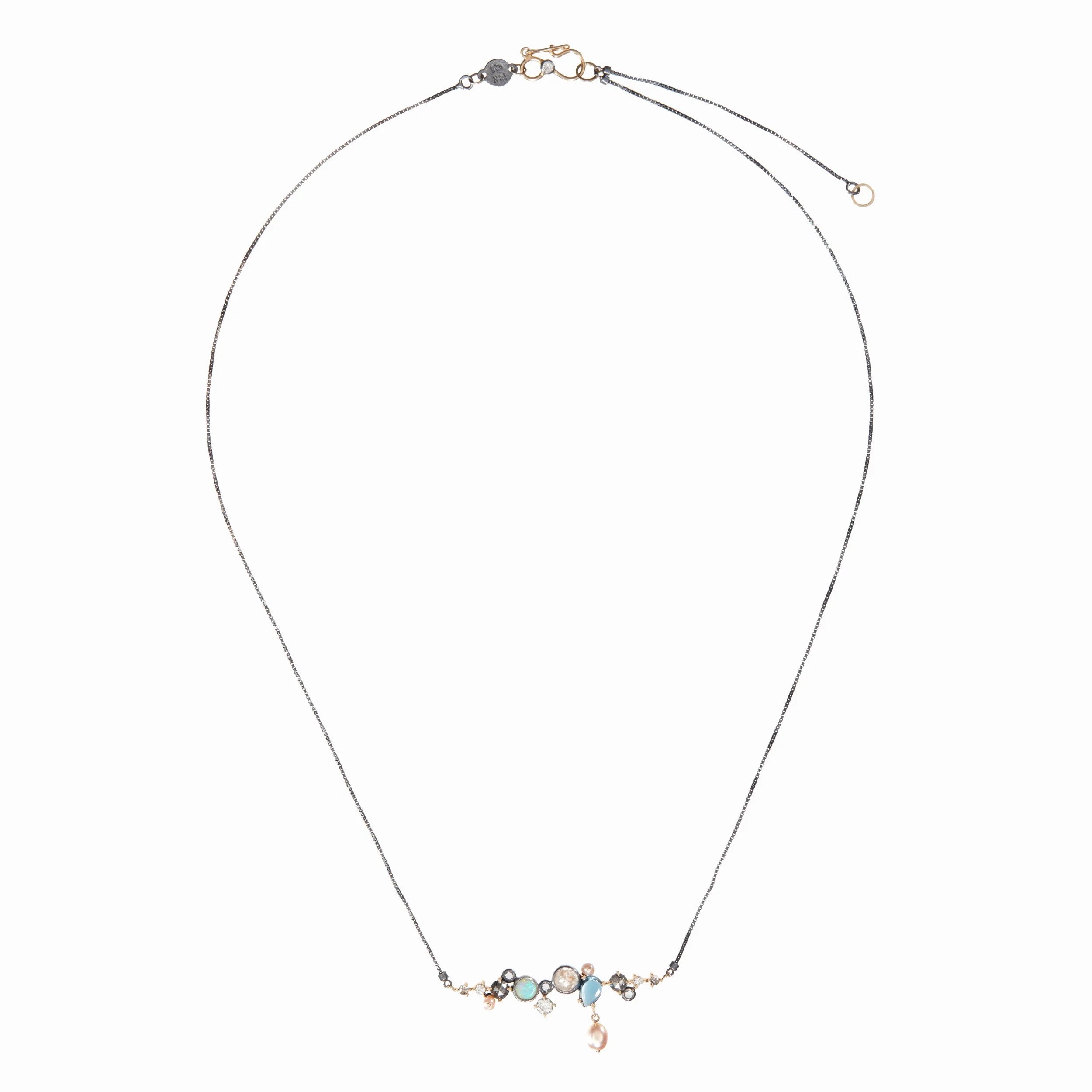 Delicate necklace with small gemstones on a white background