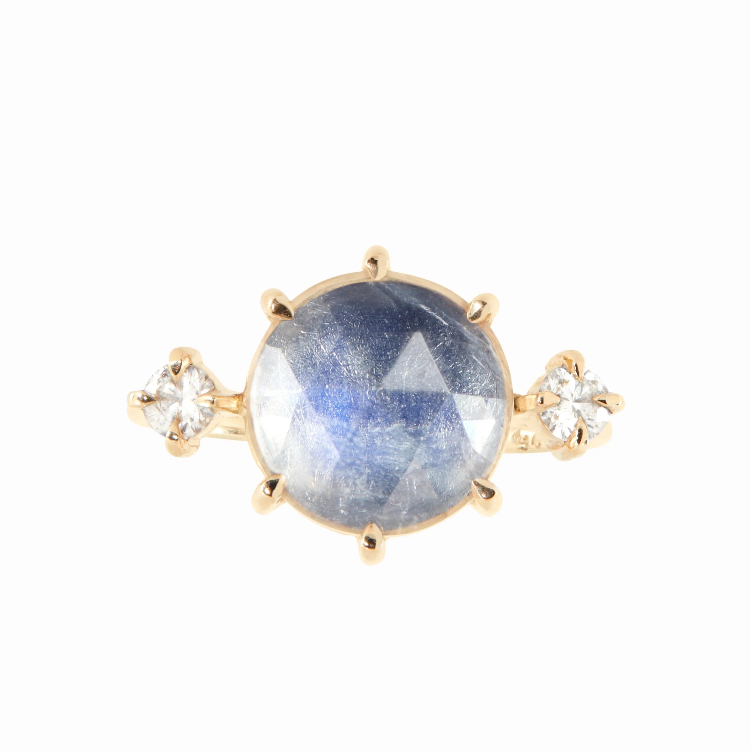 Gold ring with a blue gemstone and smaller diamonds on a white background