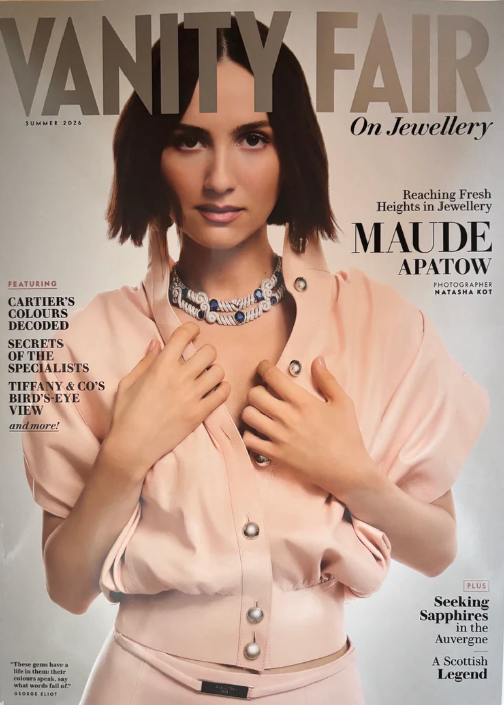Vanity Fair magazine cover featuring model Maude Apatow wearing a pale blush pink jacket and a statement blue and silver gemstone necklace. The title 'VANITY FAIR' is printed in large gray letters at the top.