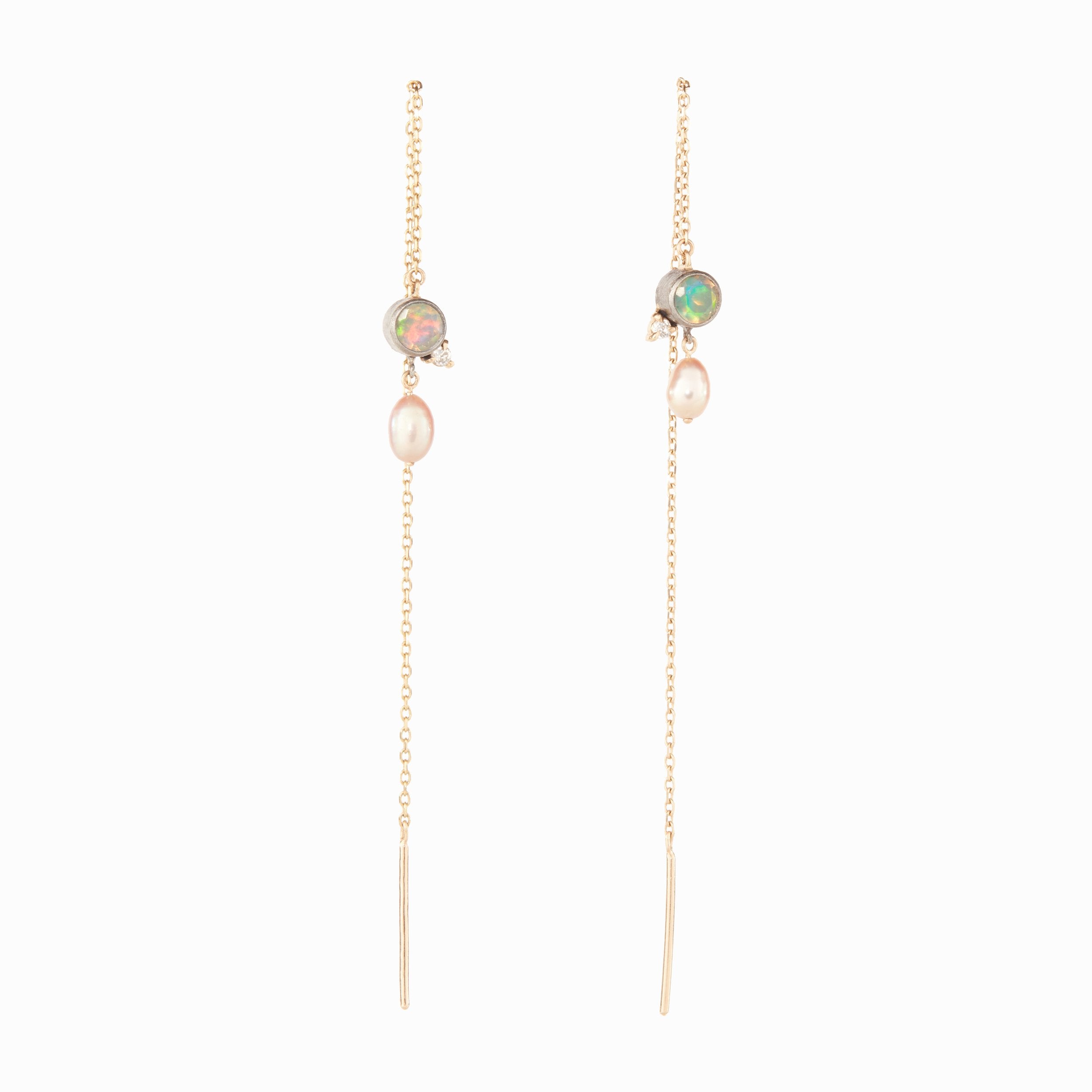 Pair of gold chain earrings with opal and pearl beads on a white background