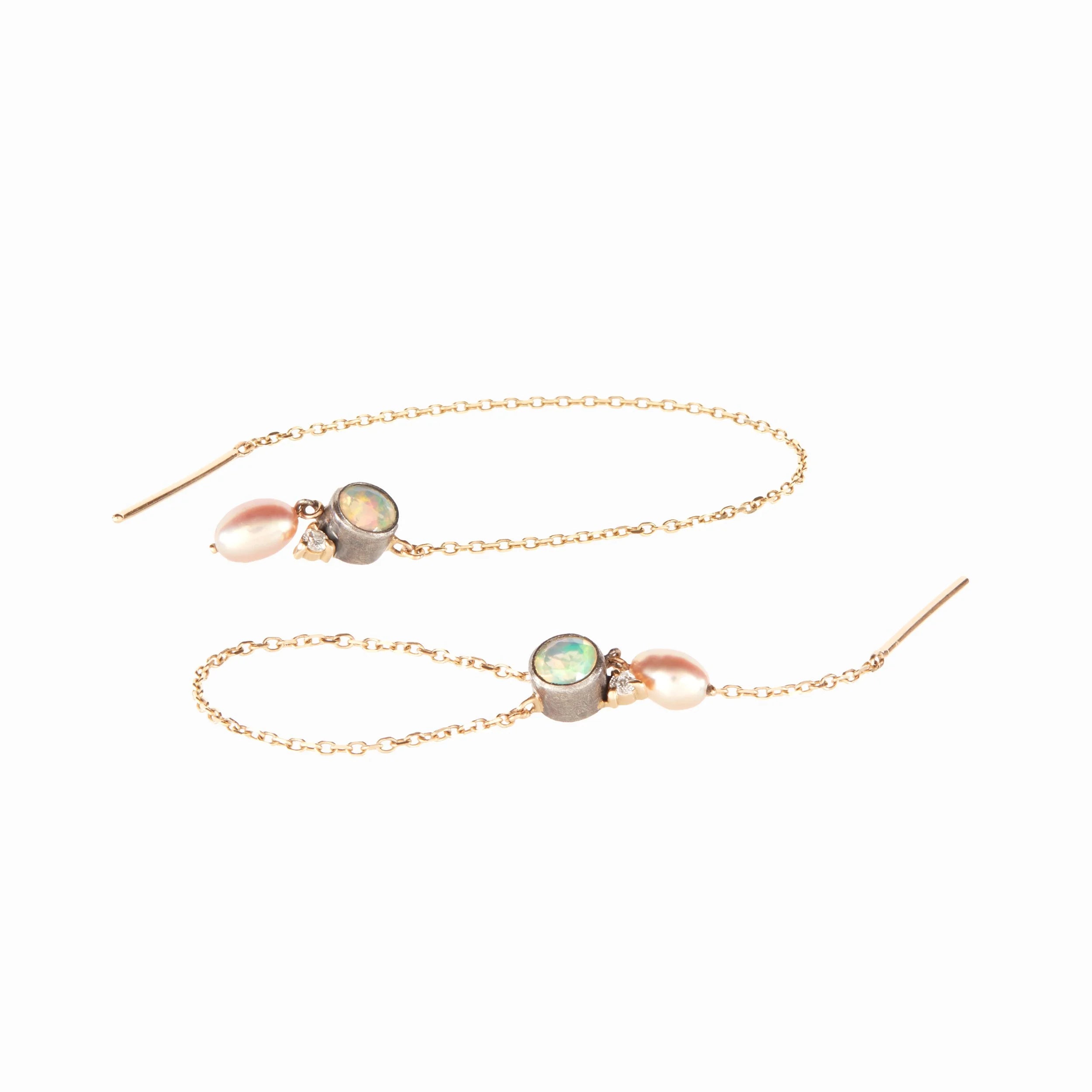 Gold threader earrings with opal and pearl stones on a white background